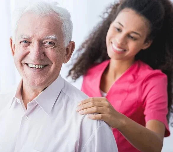 Smiling senior man receiving care from caregiver, highlighting adaptive clothing support