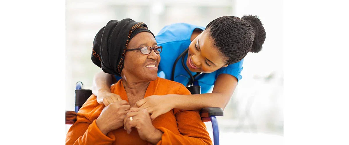 Caregiver assisting senior woman in adaptive clothing, smiling together, Ovidis Adaptive Wear