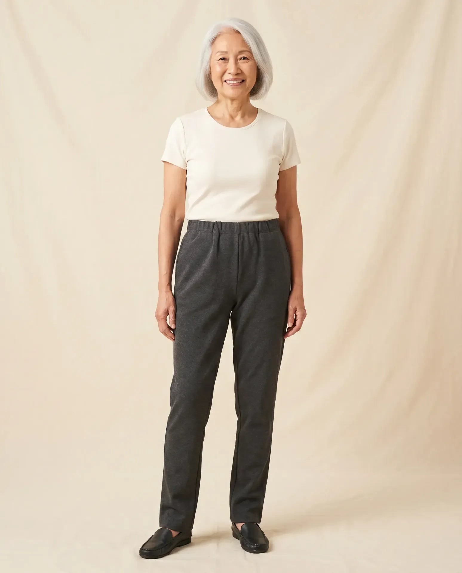 Senior Asian woman wearing Ovidis Arie Pants in Charcoal, full body front view