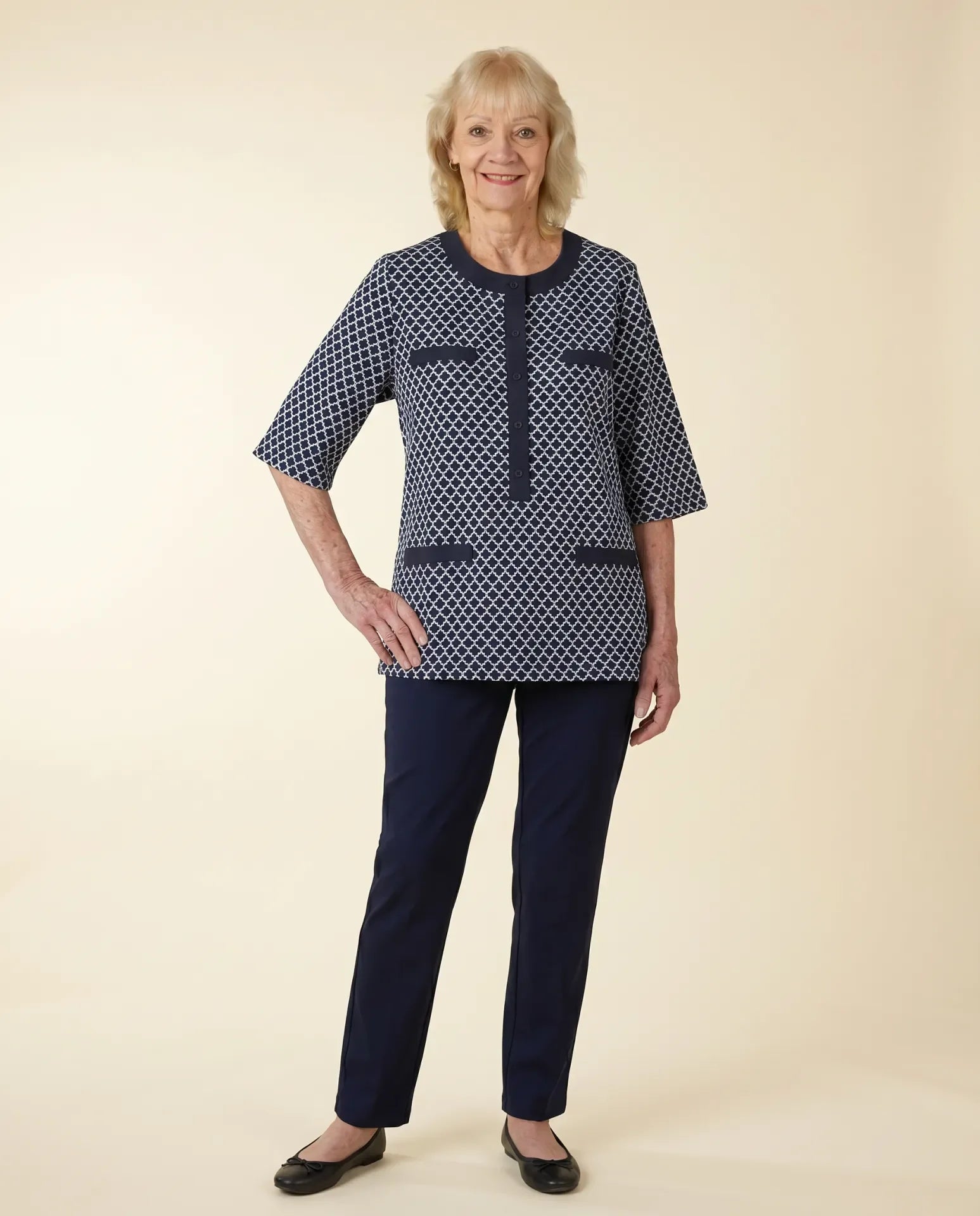 Senior woman wearing adaptive navy jacquard tunic top with elbow-length sleeves and decorative pocket welts