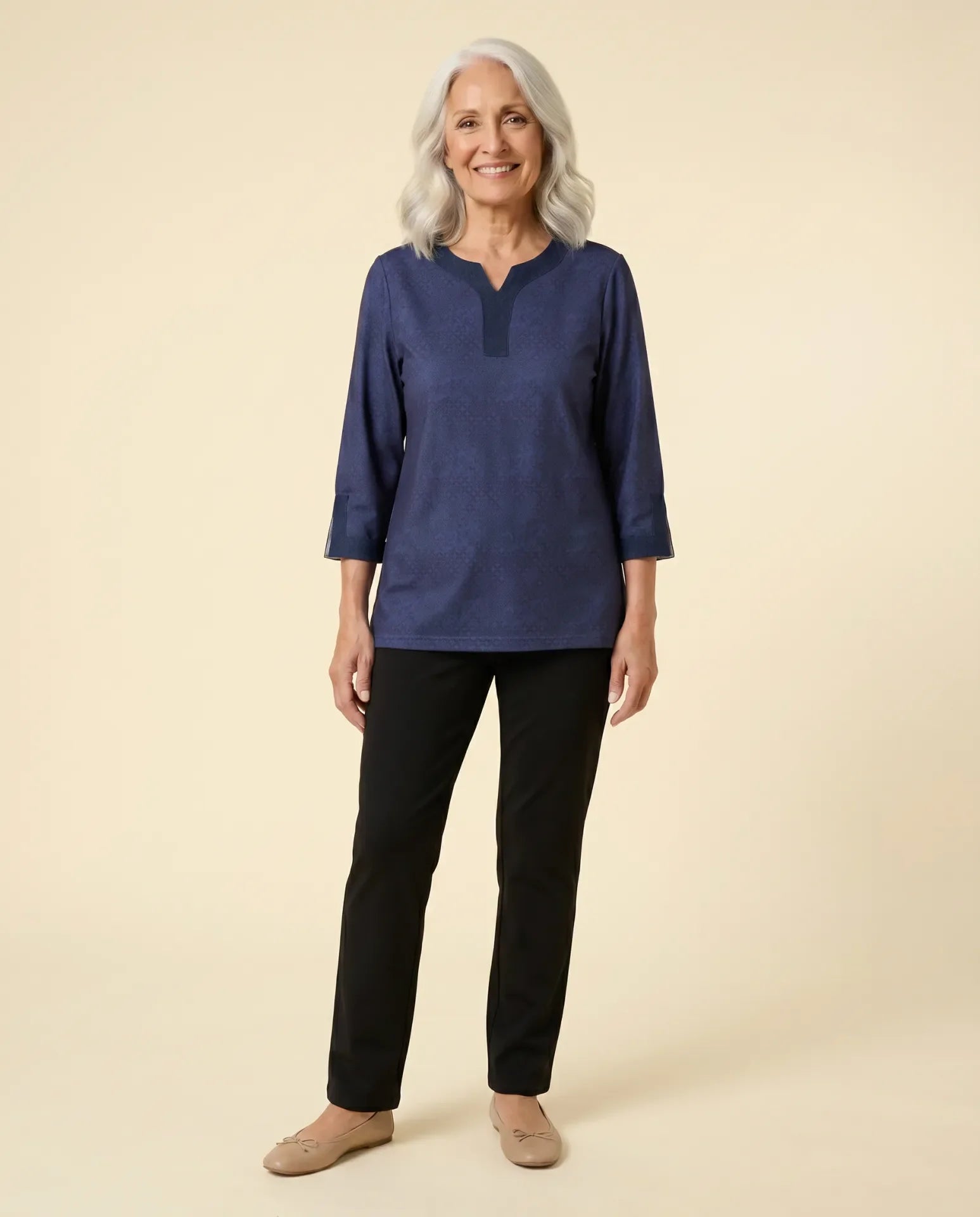 Senior woman wearing adaptive navy tonal-print top with contrast denim collar and cuff trim, paired with black pants