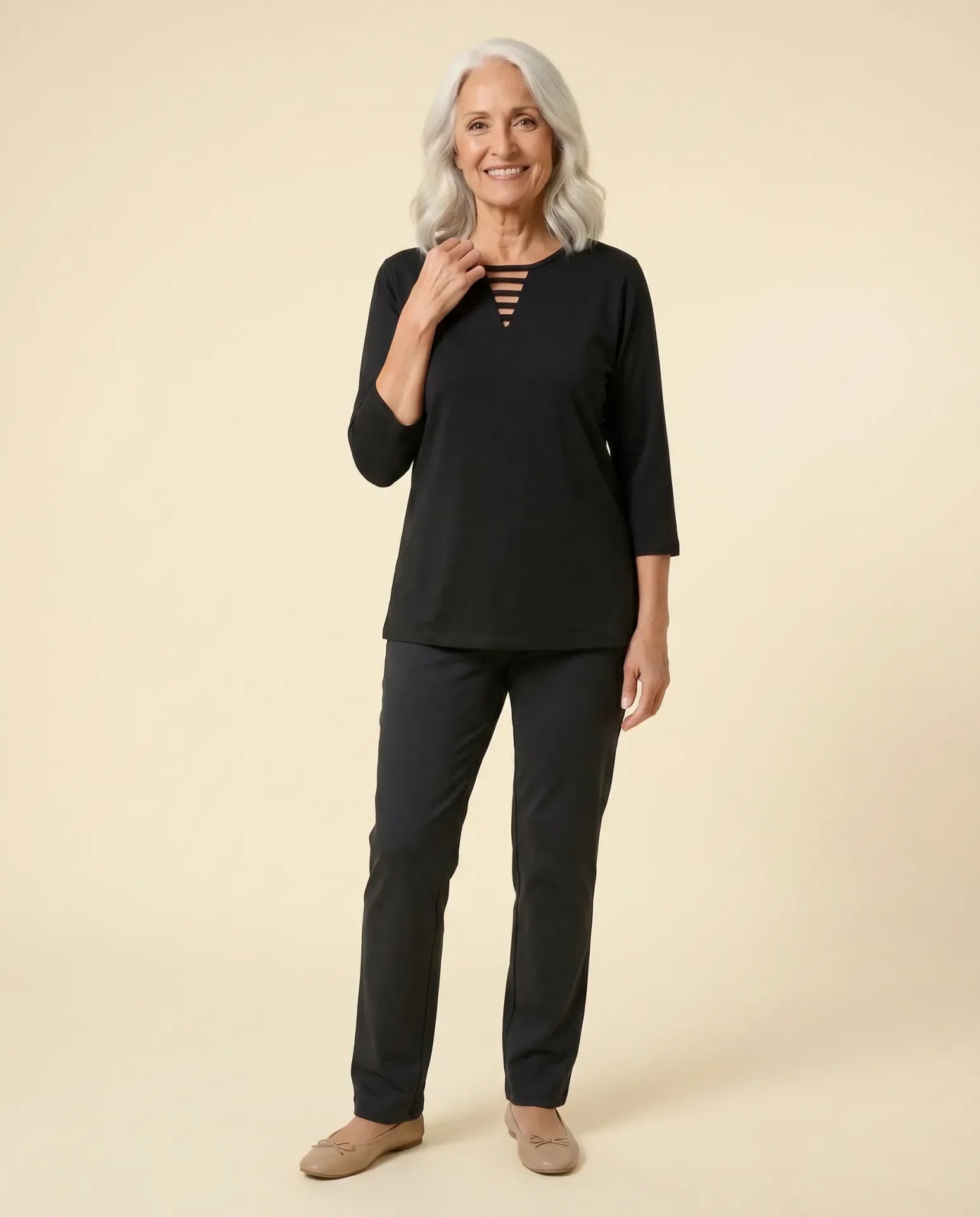 Senior woman wearing Ovidis adaptive black top with triangular ladder cutout neckline, easy assisted dressing