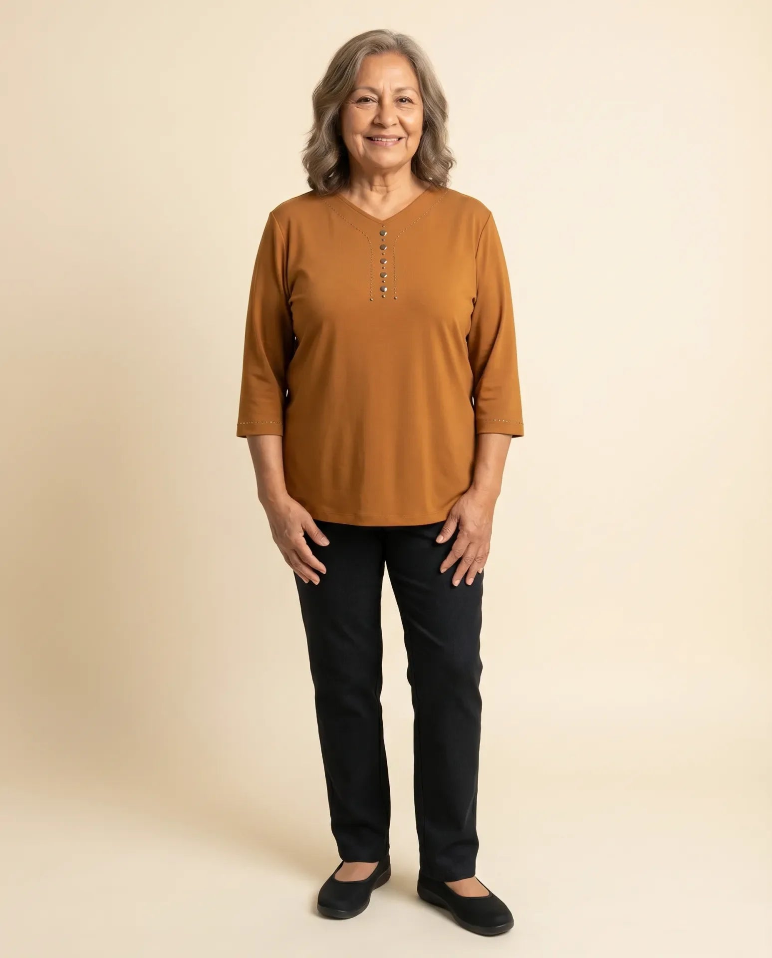 Senior woman wearing Ovidis adaptive amber top with V-neck stud button detail and cuff trim, easy dressing