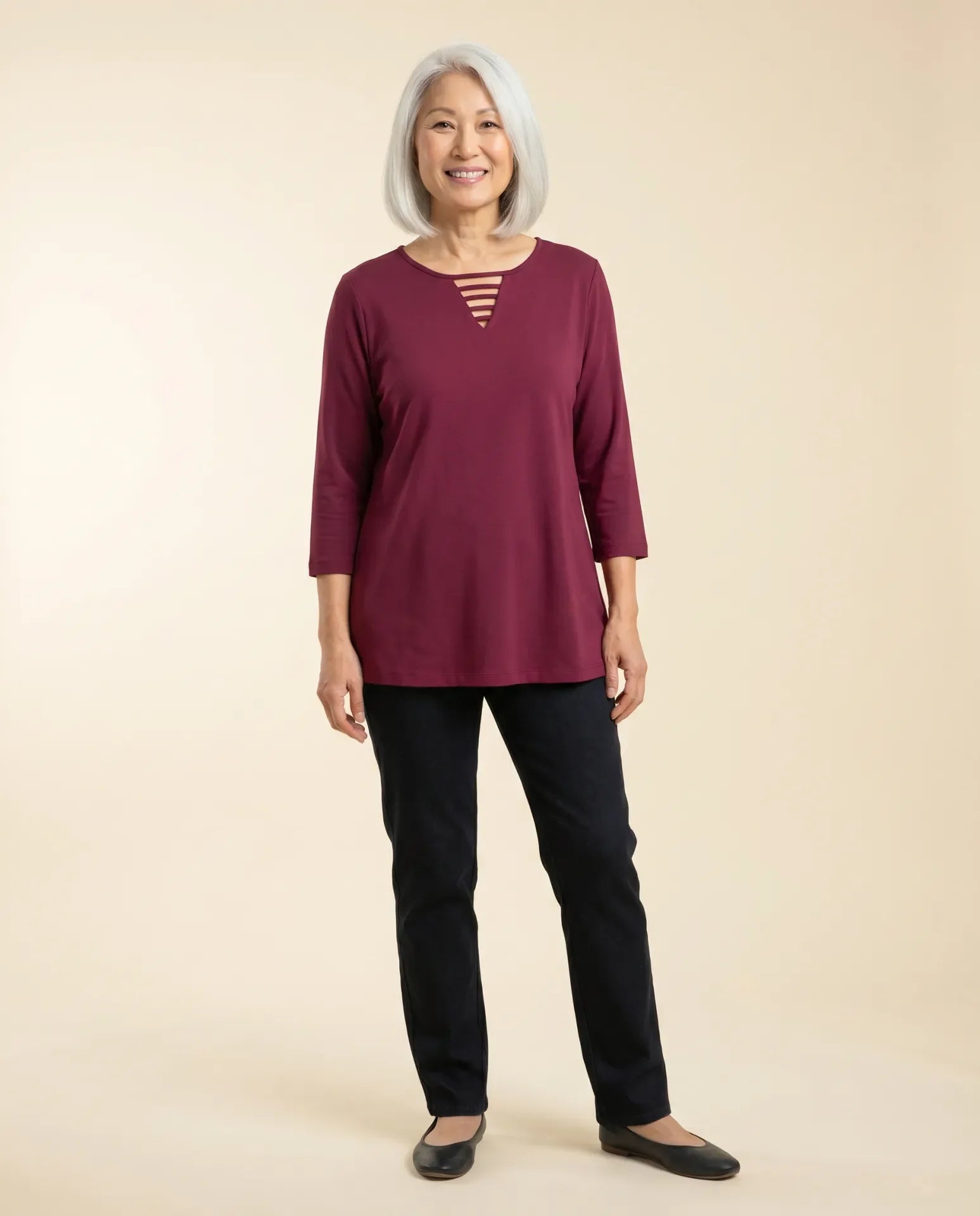 Senior woman wearing Ovidis adaptive dark wine fuchsia top with ladder neckline detail, easy dressing