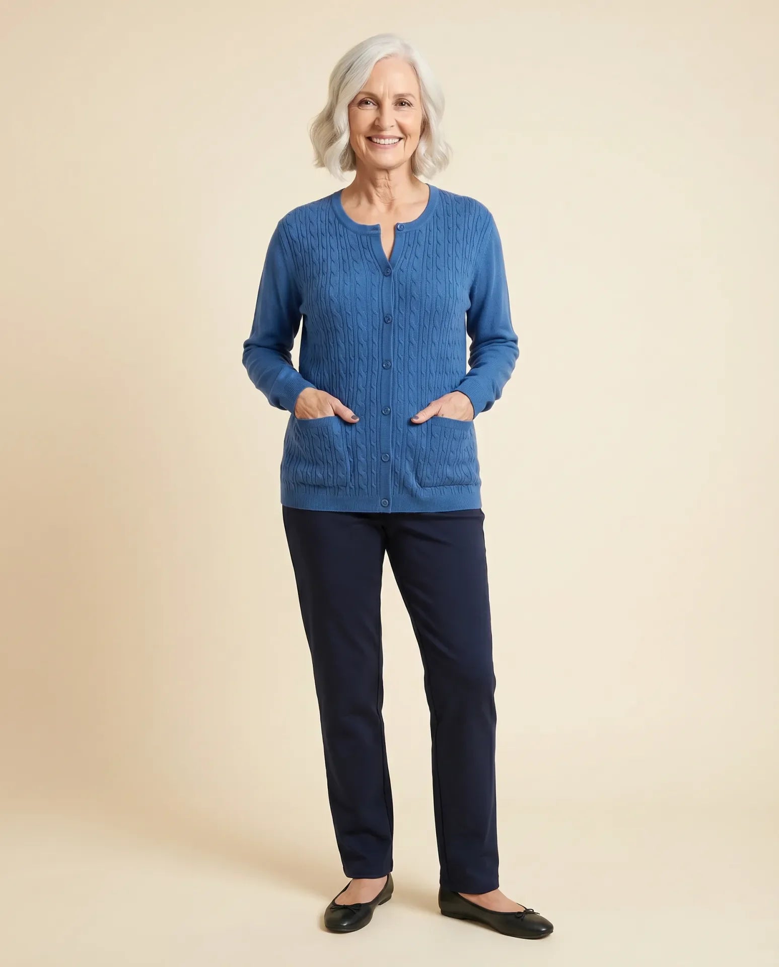 Senior woman wearing Ovidis adaptive blue Gillian cable-knit cardigan with patch pockets, easy assisted dressing