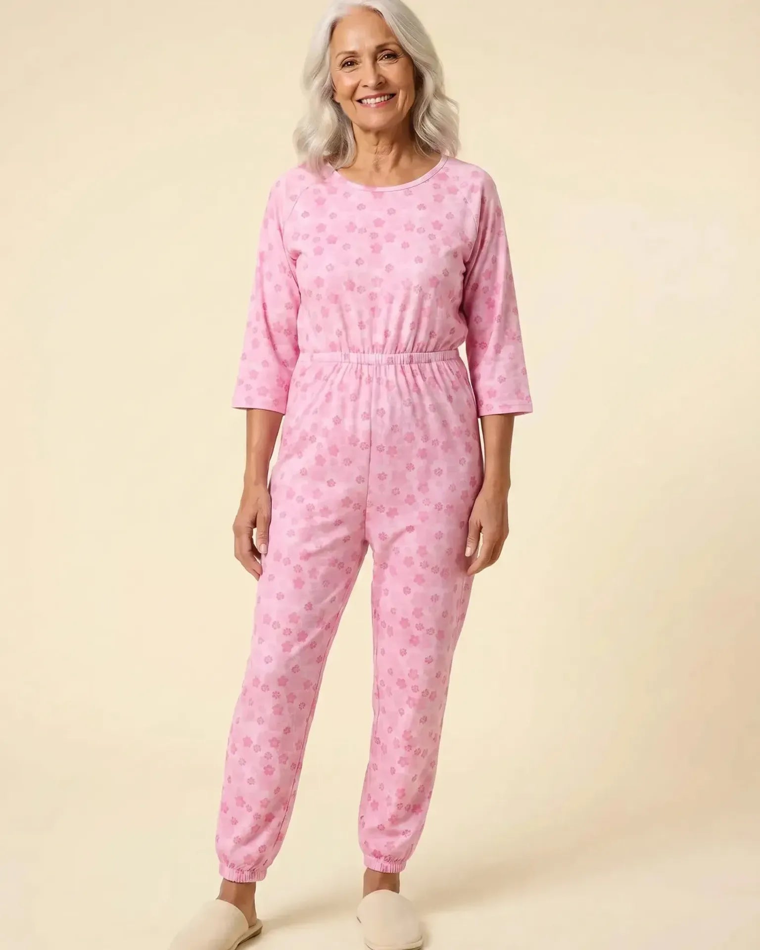 Senior woman wearing Ovidis adaptive Carrie Orchid jumpsuit, full body front view
