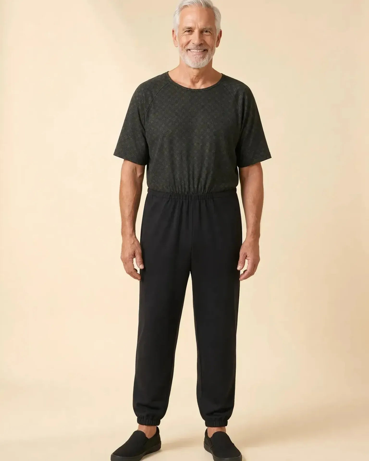 Senior man wearing Ovidis adaptive Bobby Trellis jumpsuit, full body front view