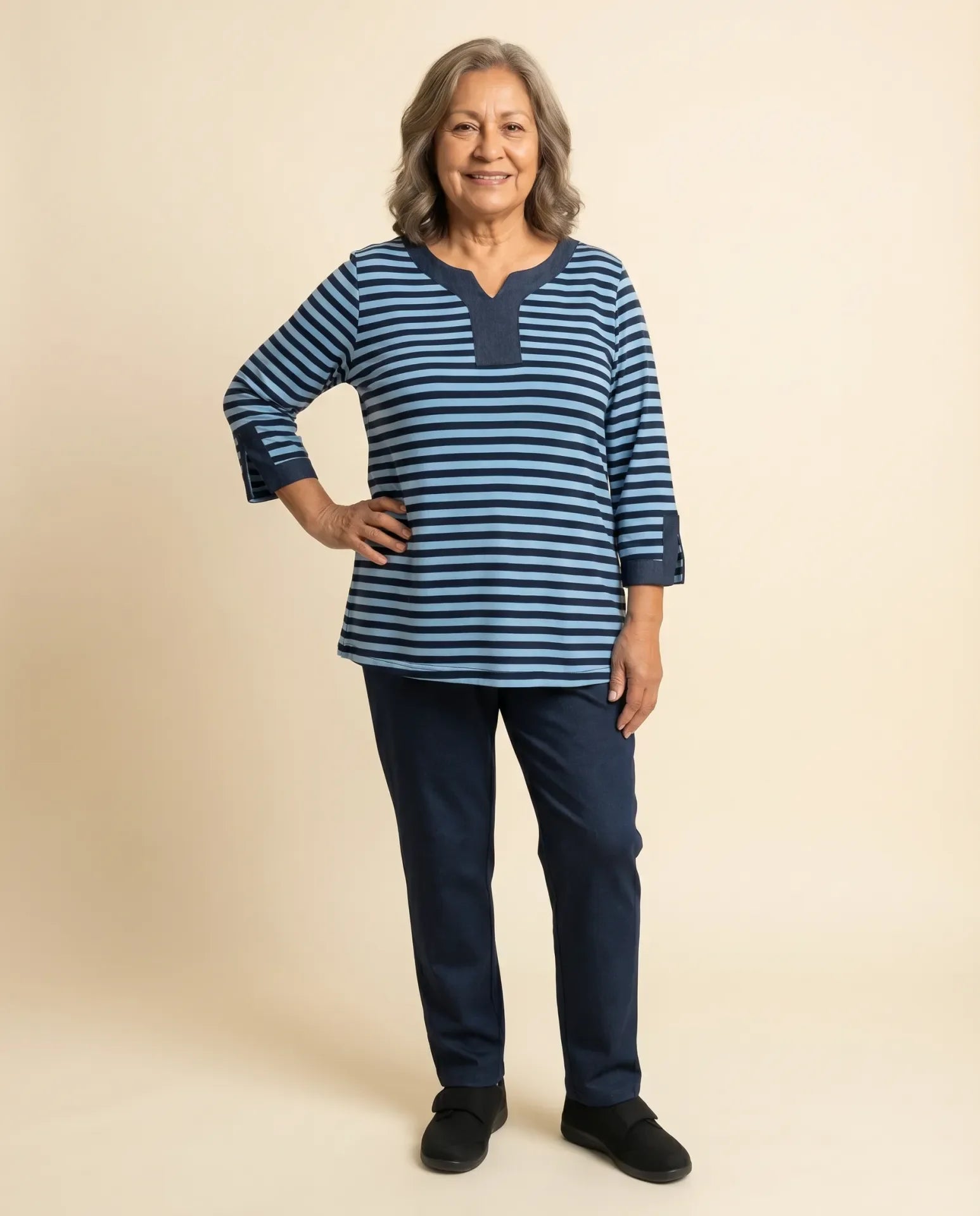 Senior woman wearing Ovidis adaptive navy striped top with denim collar and cuff detail, easy dressing