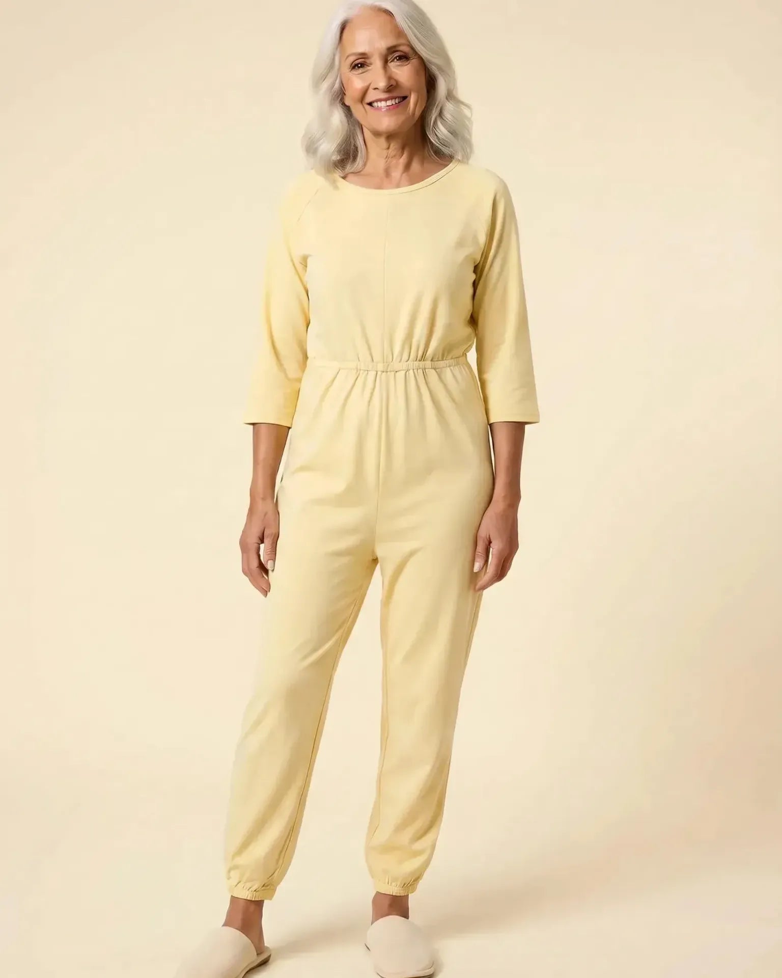 Senior woman wearing Ovidis adaptive Carrie Yellow jumpsuit, full body front view