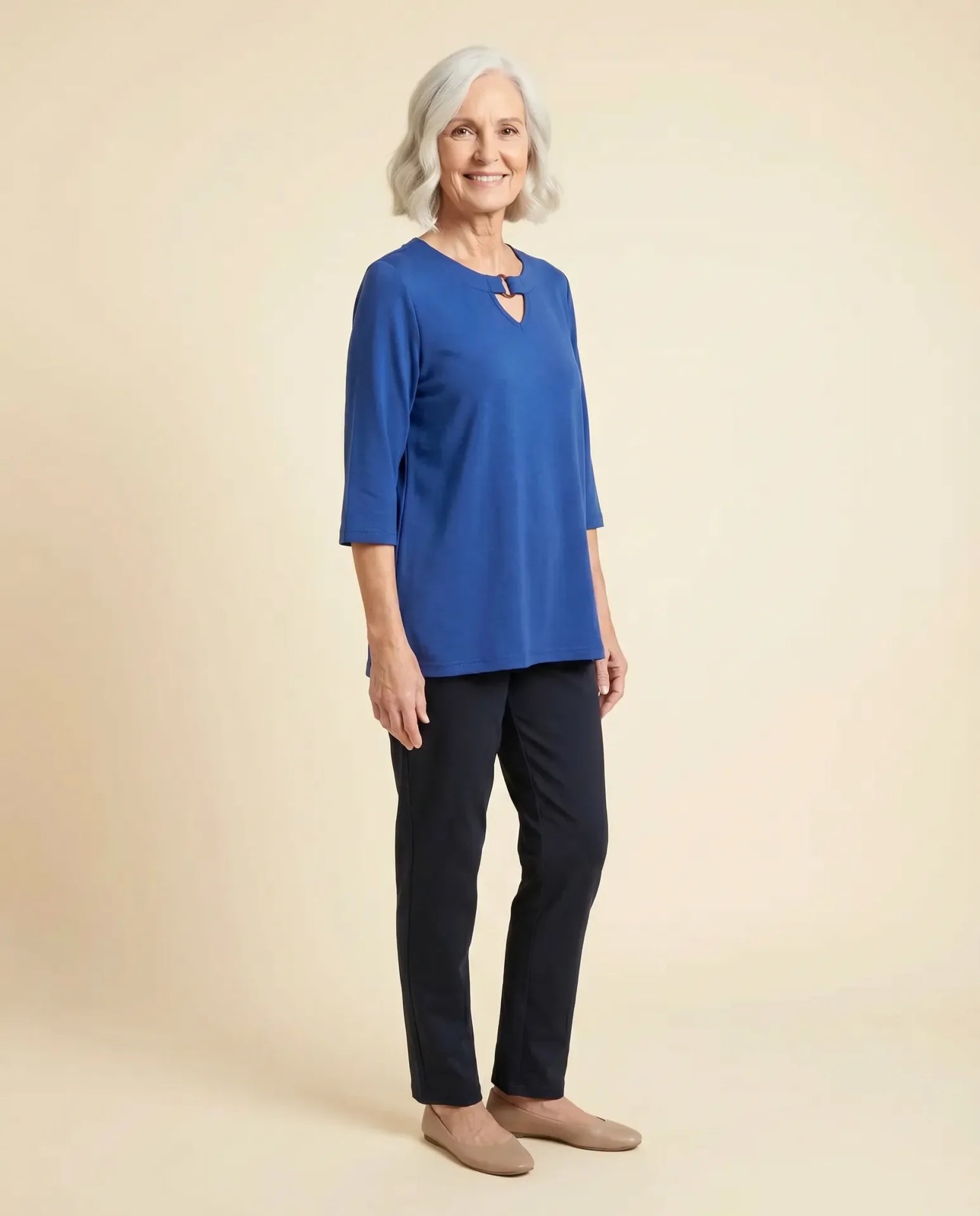 Senior woman wearing Ovidis adaptive blue knit top with keyhole neckline, easy assisted dressing