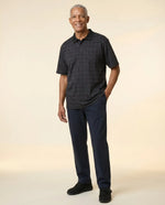 Senior man wearing Ovidis adaptive black check polo shirt