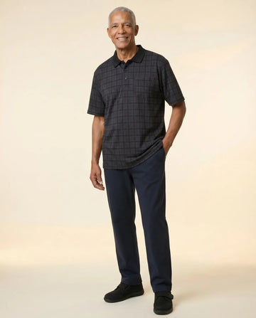 Senior man wearing Ovidis adaptive black check polo shirt