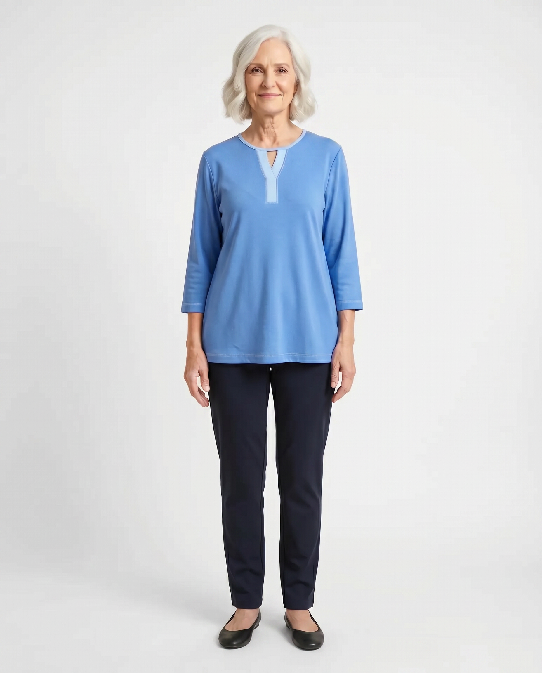 Senior woman wearing Ovidis adaptive blue Ava top with contrast Y-insert neckline, easy assisted dressing
