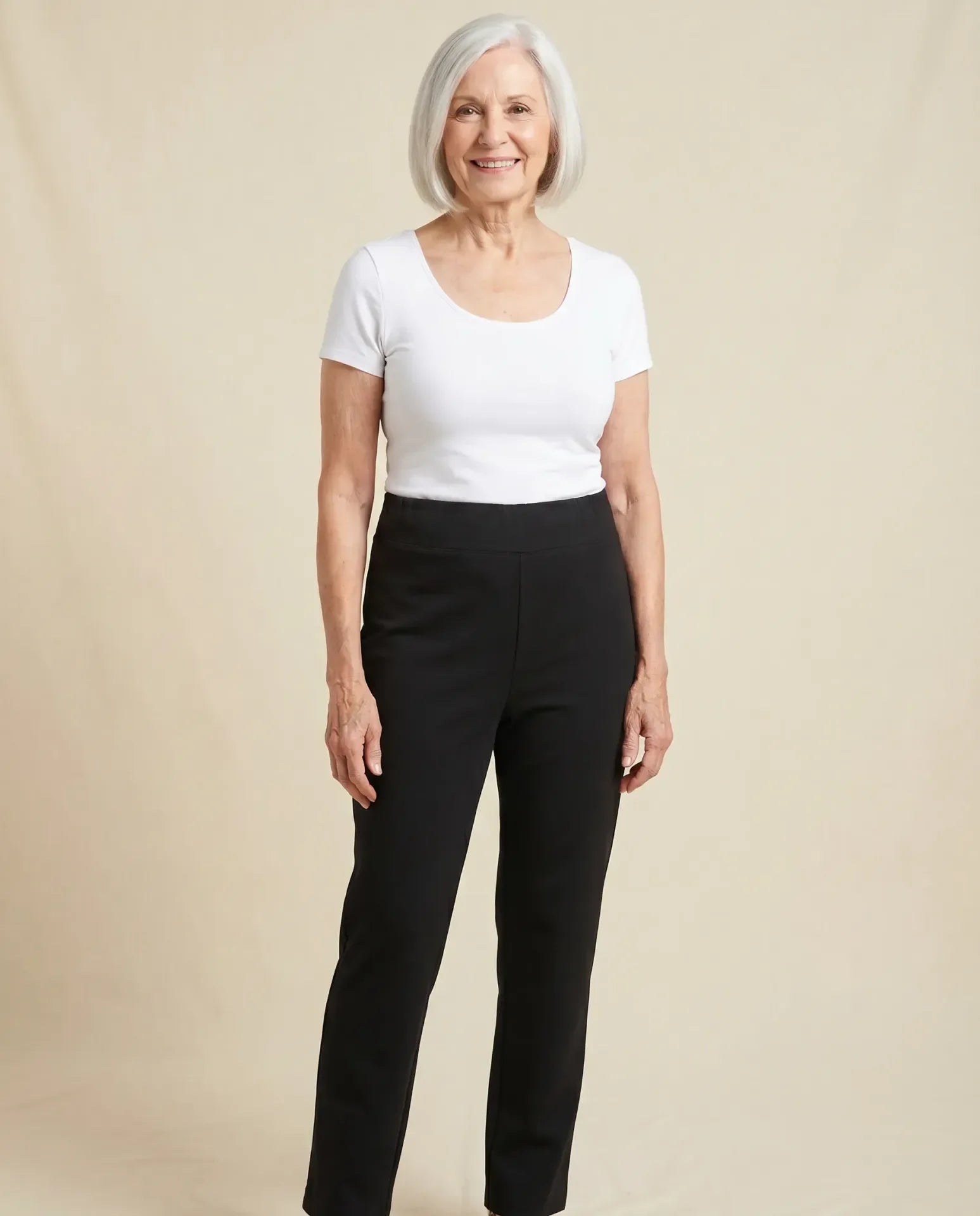 Senior woman wearing Ovidis Tricotti adaptive black pants, full body front view