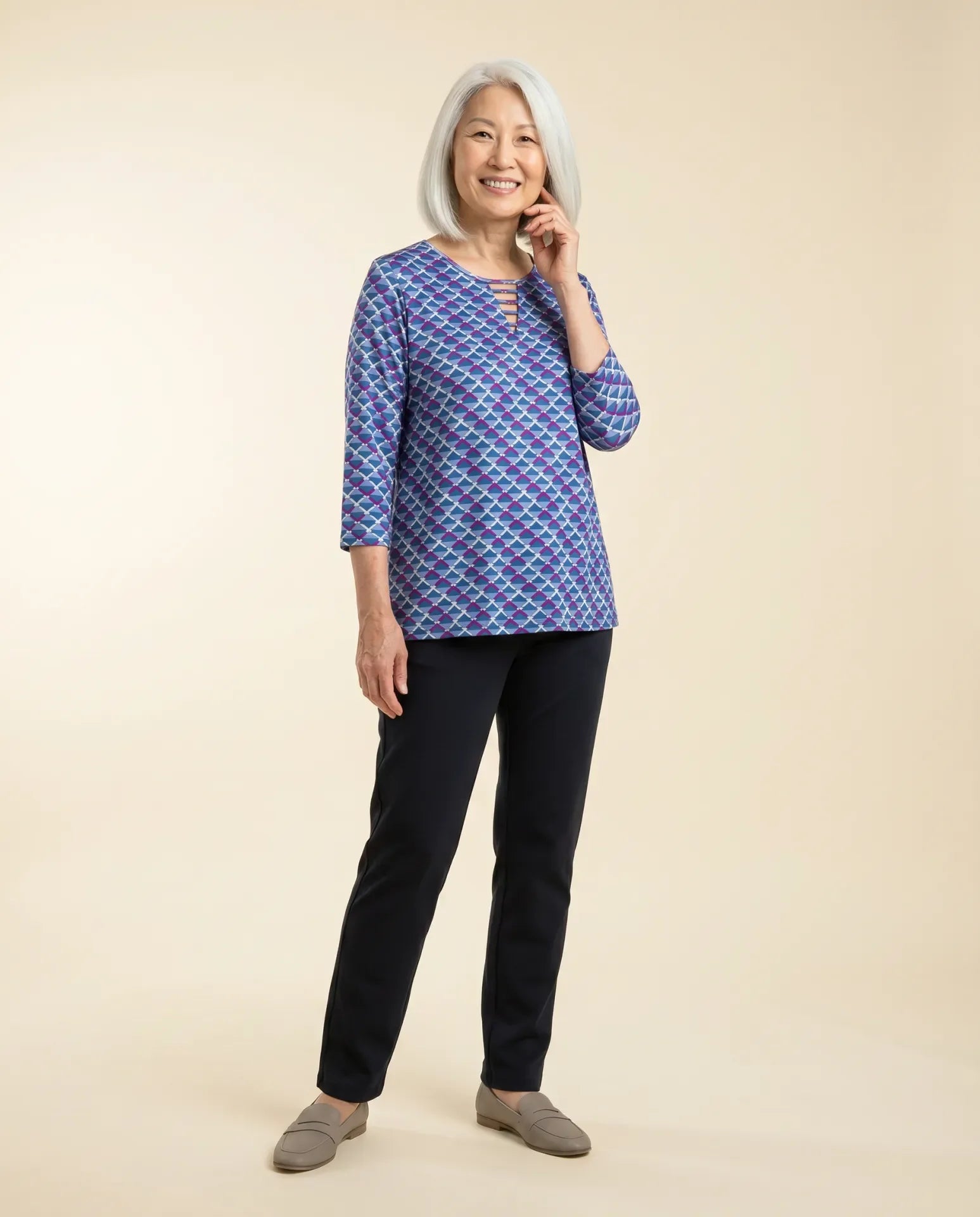 Senior woman wearing Ovidis adaptive cobalt geometric top with ladder neckline, easy dressing