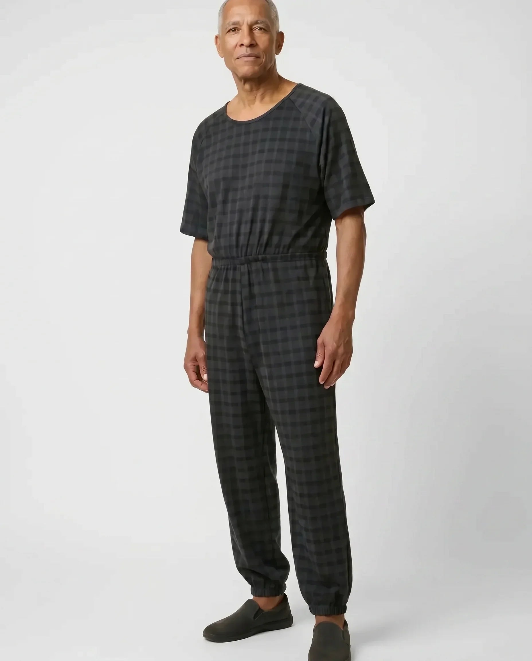 Senior man wearing Ovidis adaptive Bobby Black Check jumpsuit, full body front view