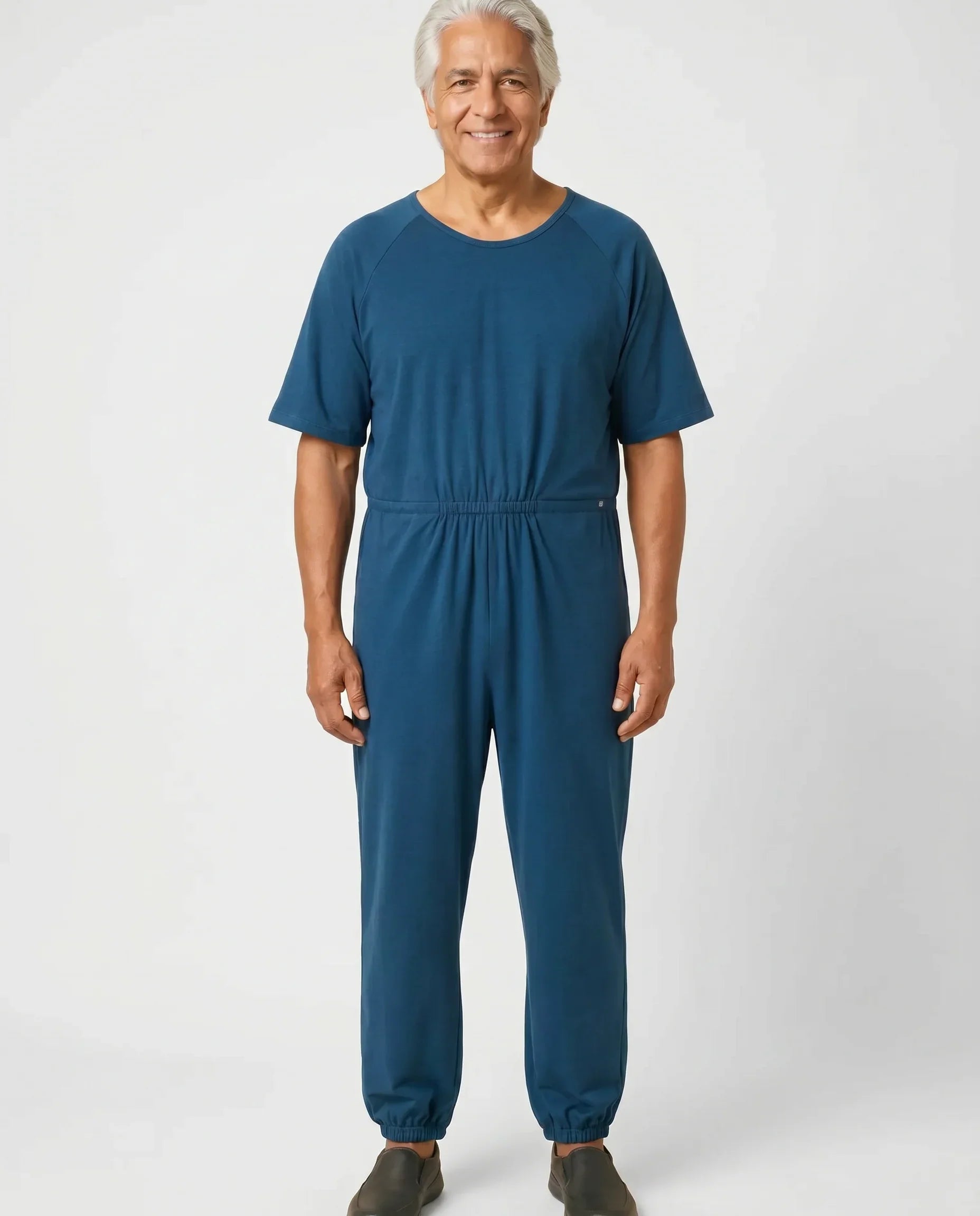 Senior man wearing Ovidis adaptive Bobby Teal jumpsuit, full body front view