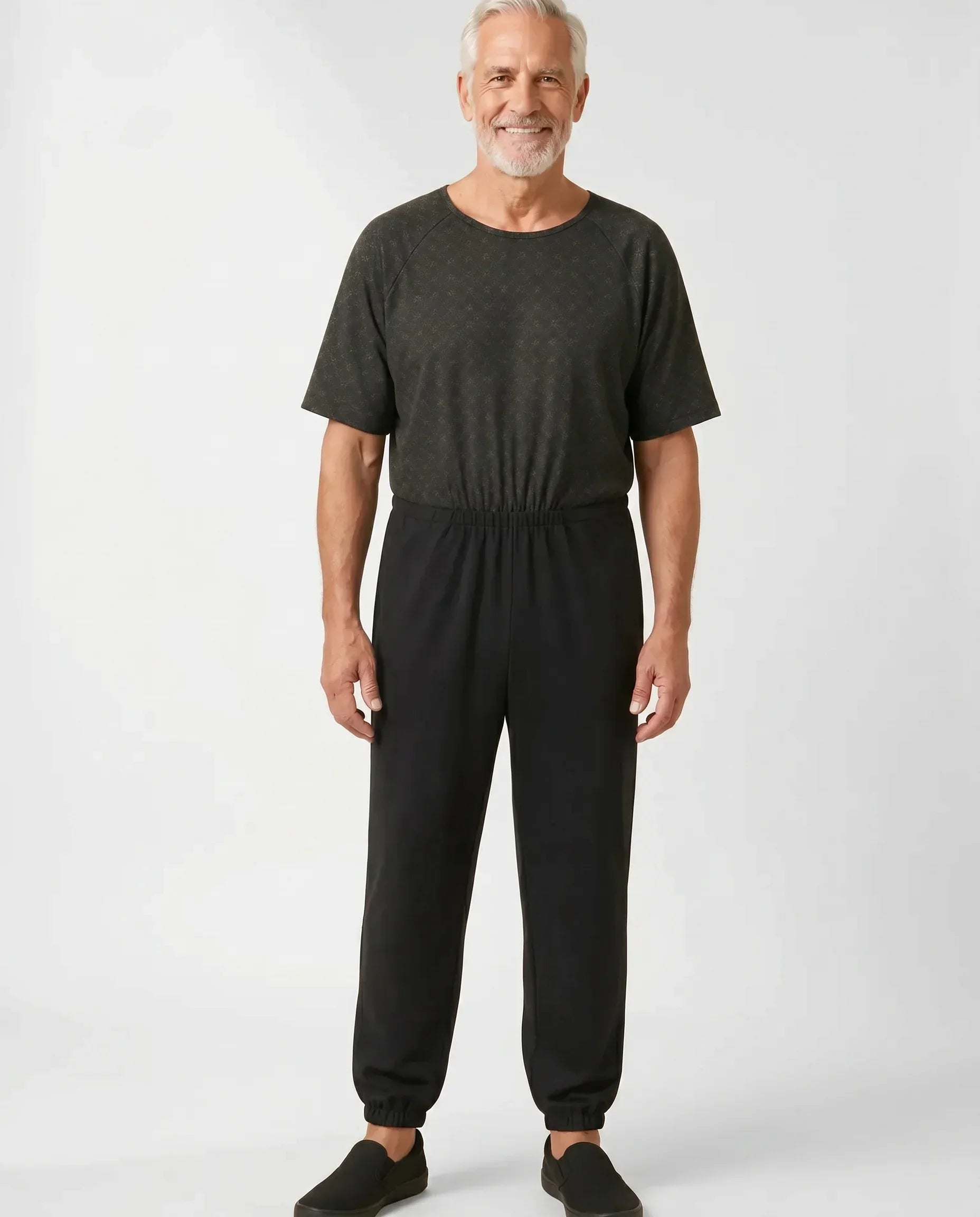 Senior man wearing Ovidis adaptive Bobby Trellis jumpsuit, full body front view