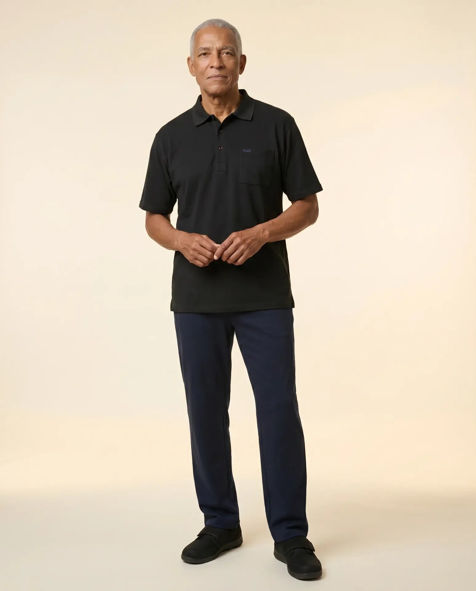 Senior man wearing Ovidis adaptive black polo shirt