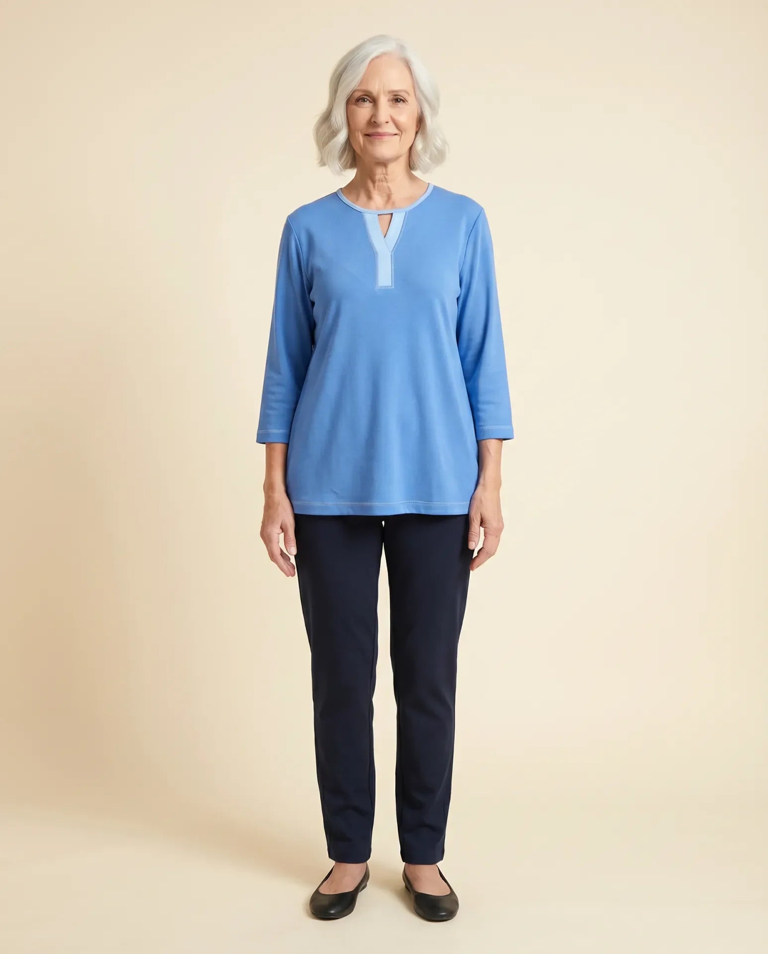 Senior woman wearing Ovidis adaptive blue Ava top with contrast Y-insert neckline, easy assisted dressing