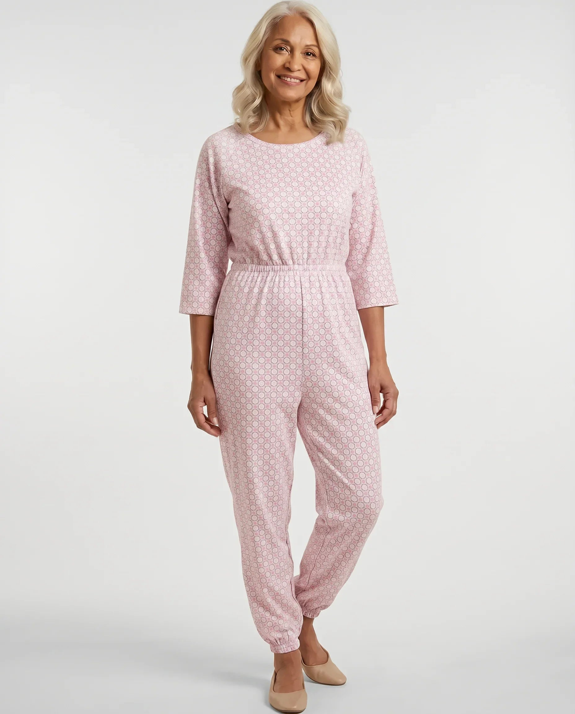 Senior woman wearing Ovidis adaptive Carrie Blush geometric jumpsuit, full body front view
