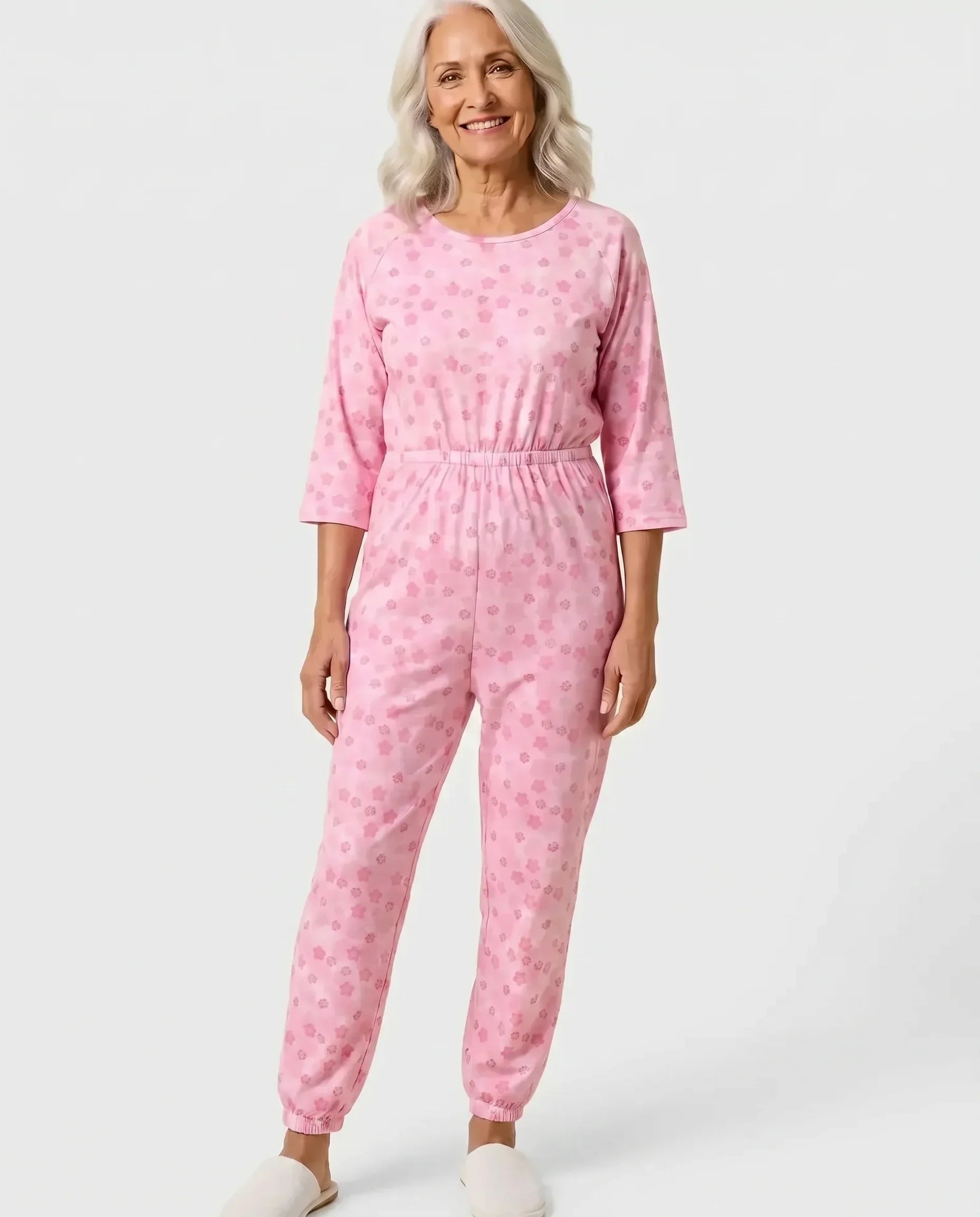 Senior woman wearing Ovidis adaptive Carrie Orchid jumpsuit, full body front view