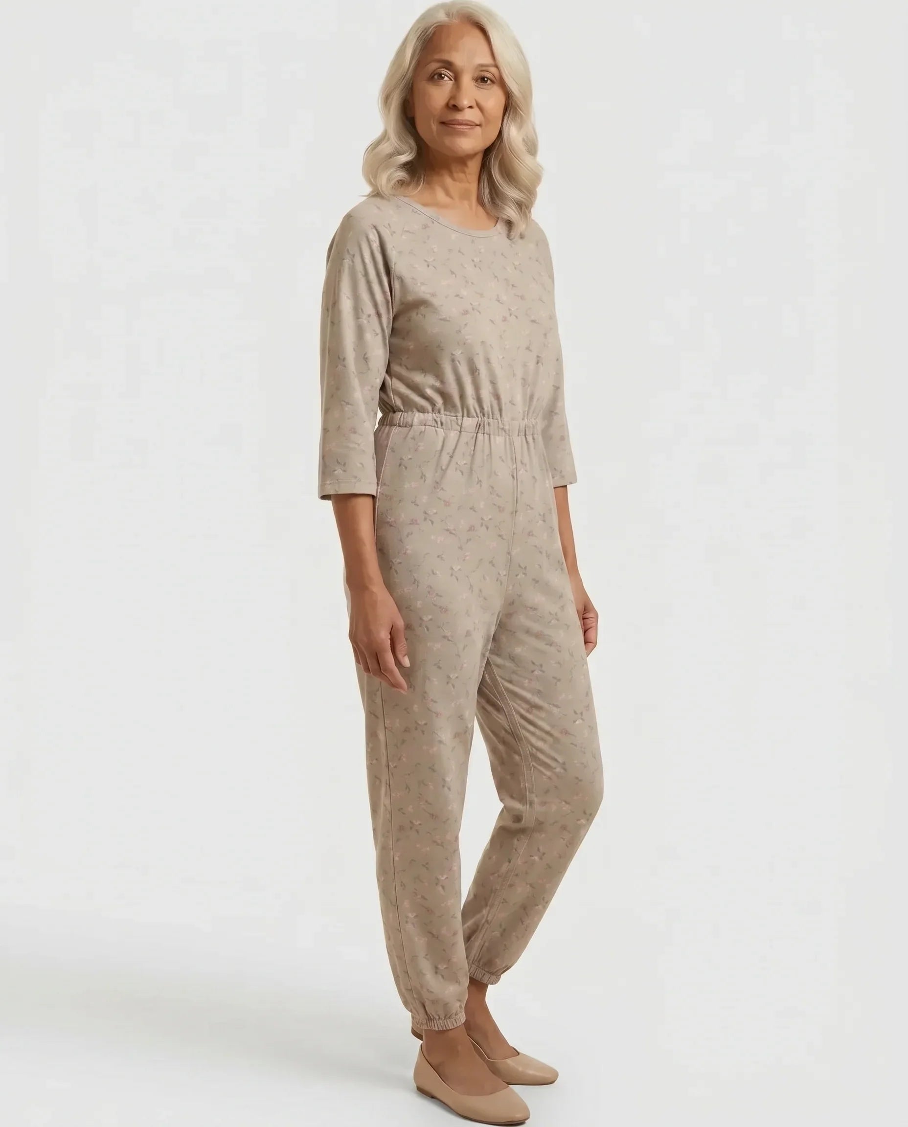 Senior woman wearing Ovidis adaptive Carrie Taupe floral jumpsuit, full body front view