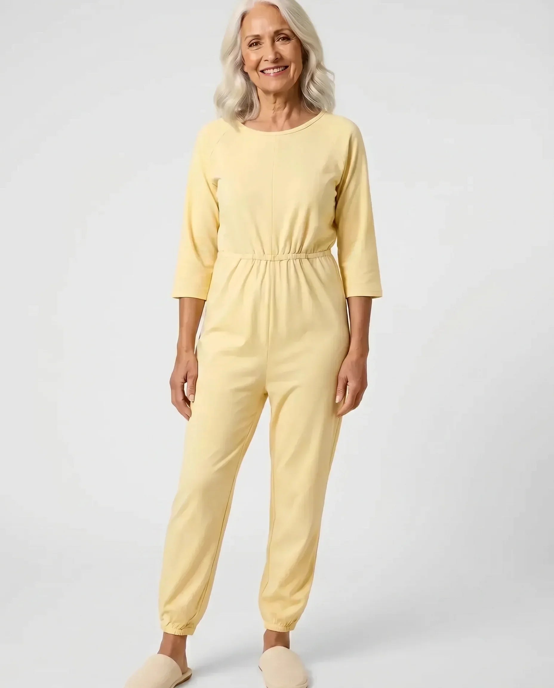 Senior woman wearing Ovidis adaptive Carrie Yellow jumpsuit, full body front view