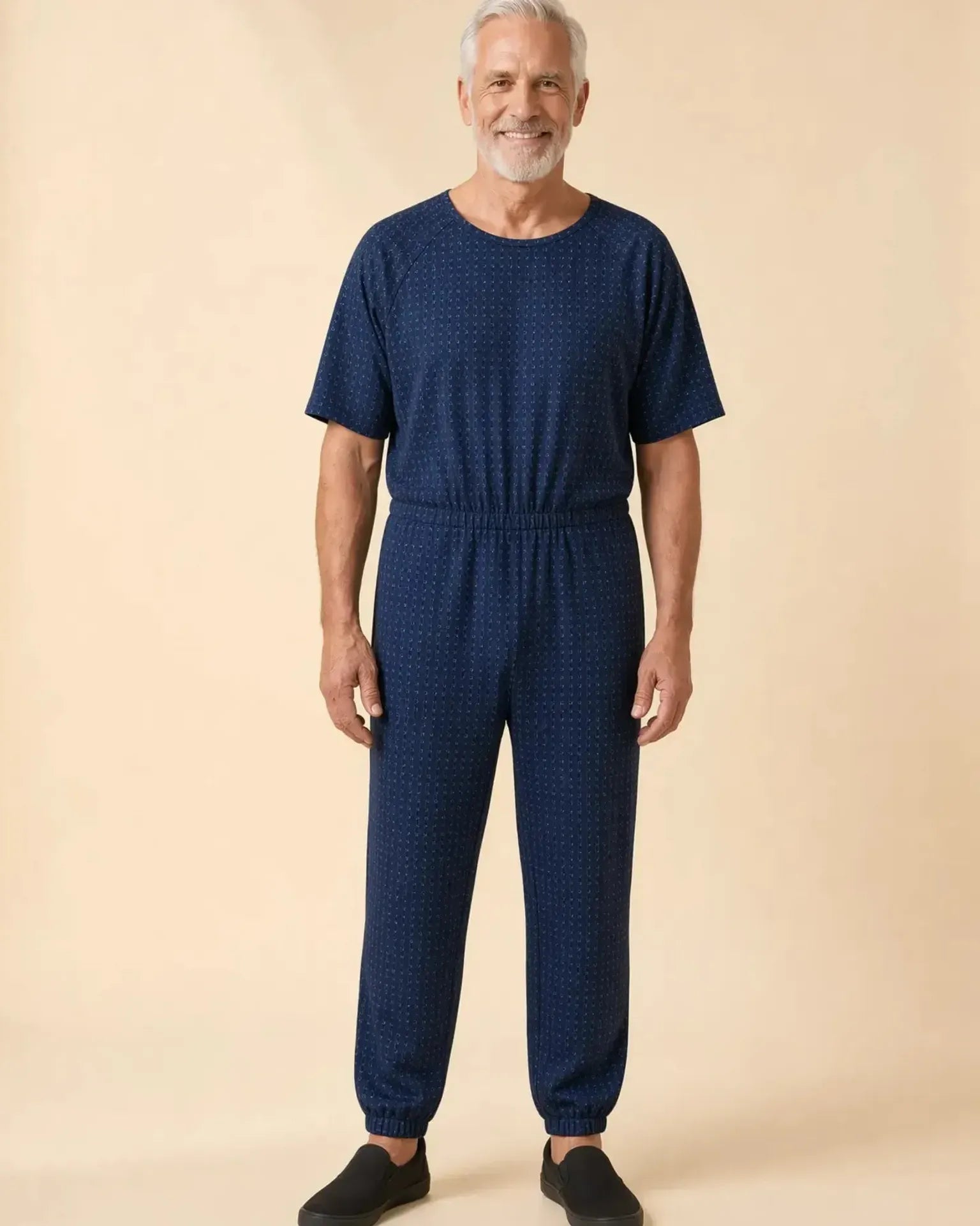 Senior man wearing Ovidis adaptive Bobby Twilight jumpsuit, full body front view