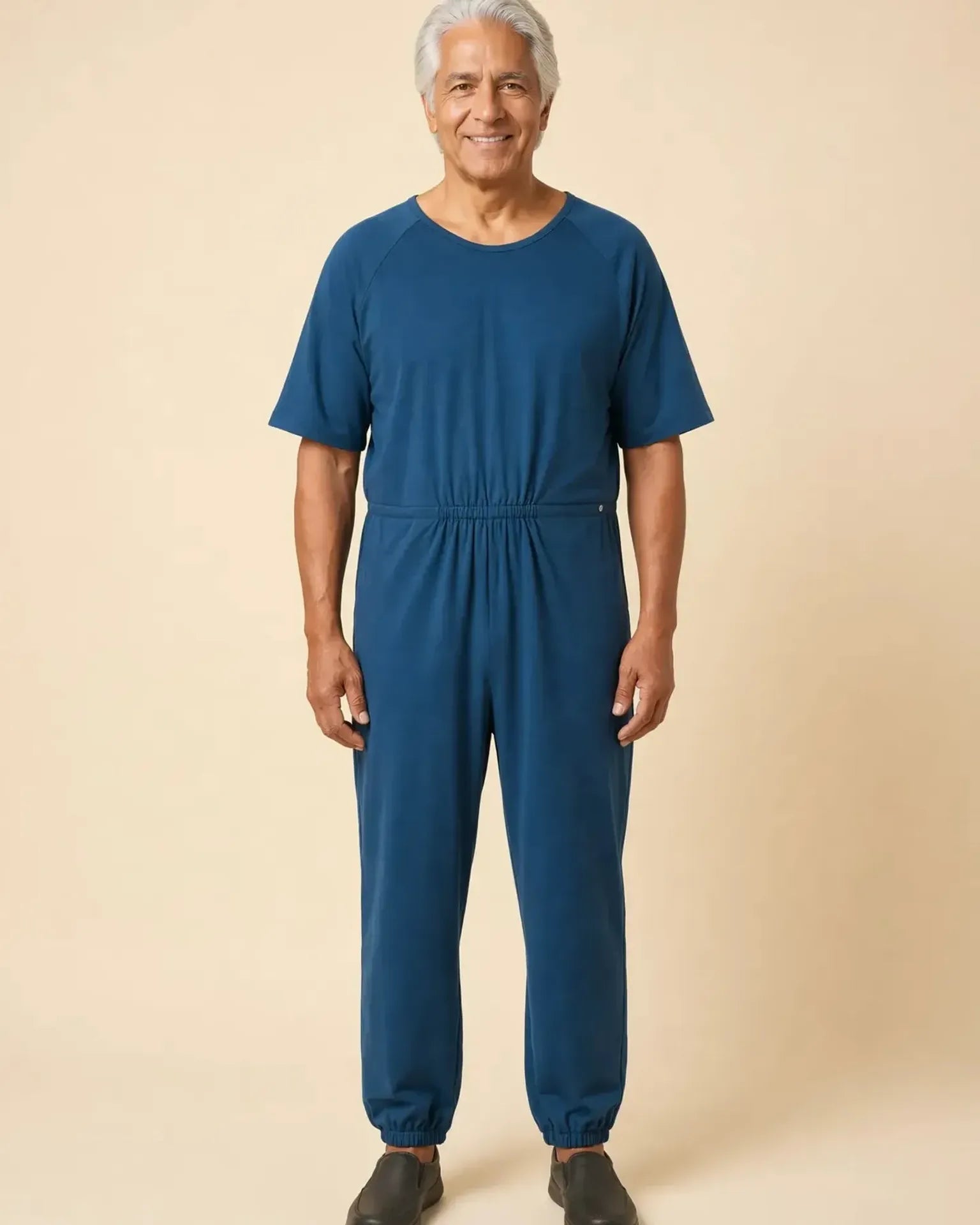 Senior man wearing Ovidis adaptive Bobby Teal jumpsuit, full body front view