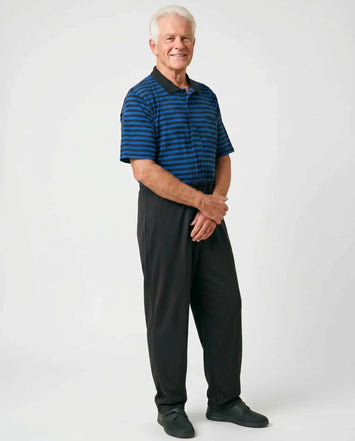 Senior man wearing Charly Blue adaptive jumpsuit — royal blue and black stripe polo top with black pants