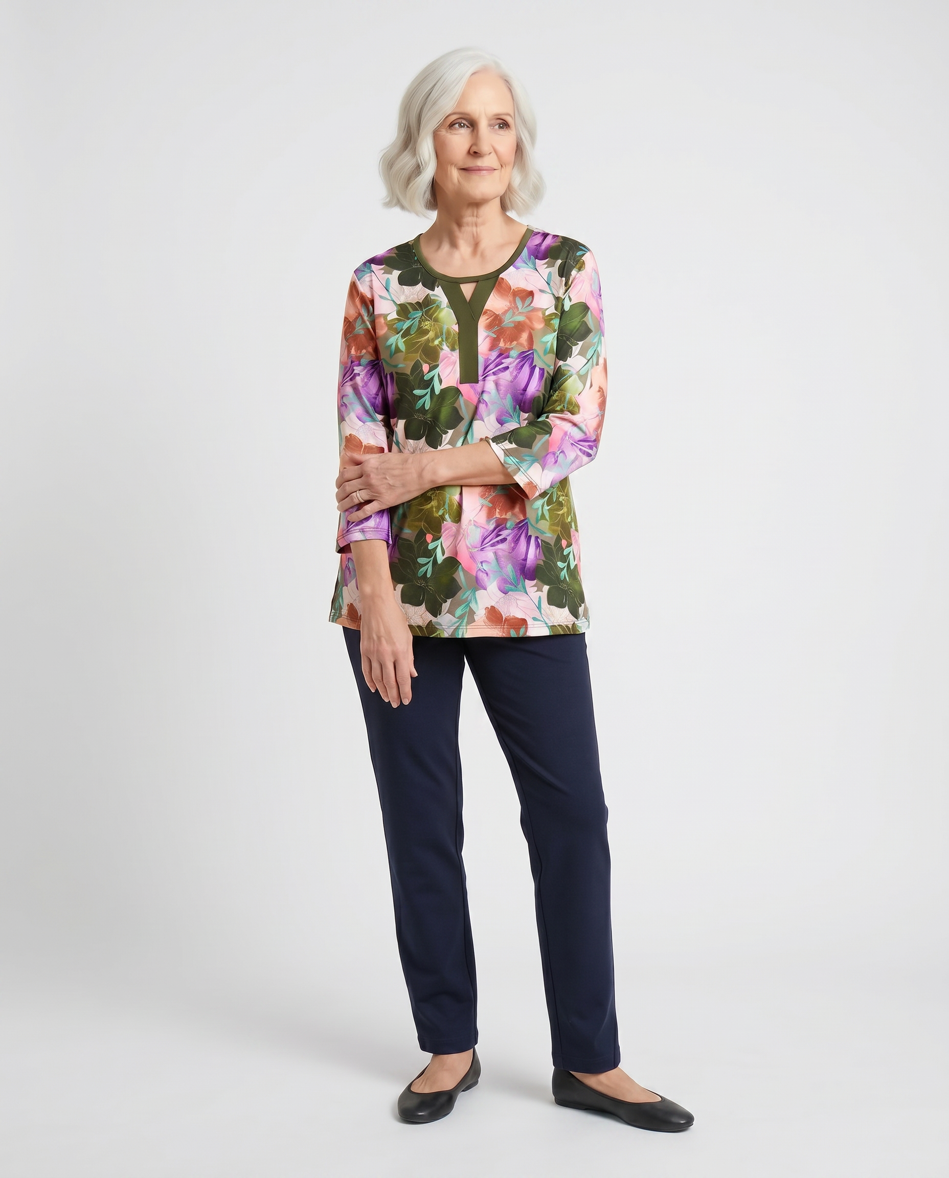 Senior woman wearing Ovidis adaptive olive botanical floral top with contrast Y-insert, easy dressing