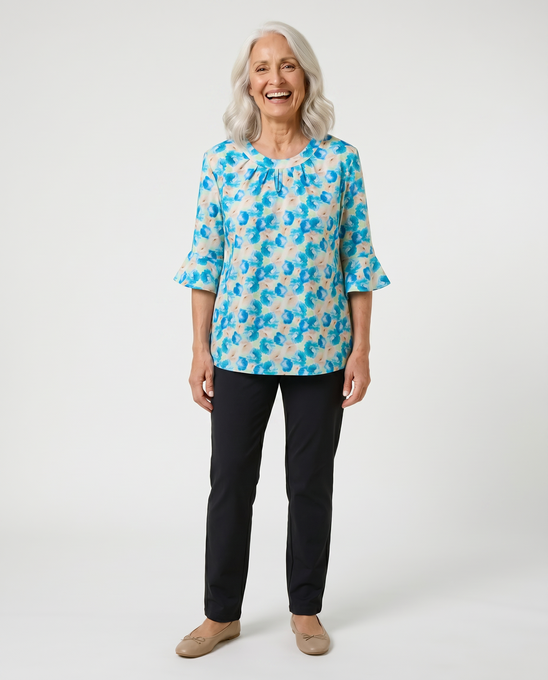 Senior woman wearing Ovidis adaptive blue floral bell sleeve top with pleated keyhole neckline, easy dressing