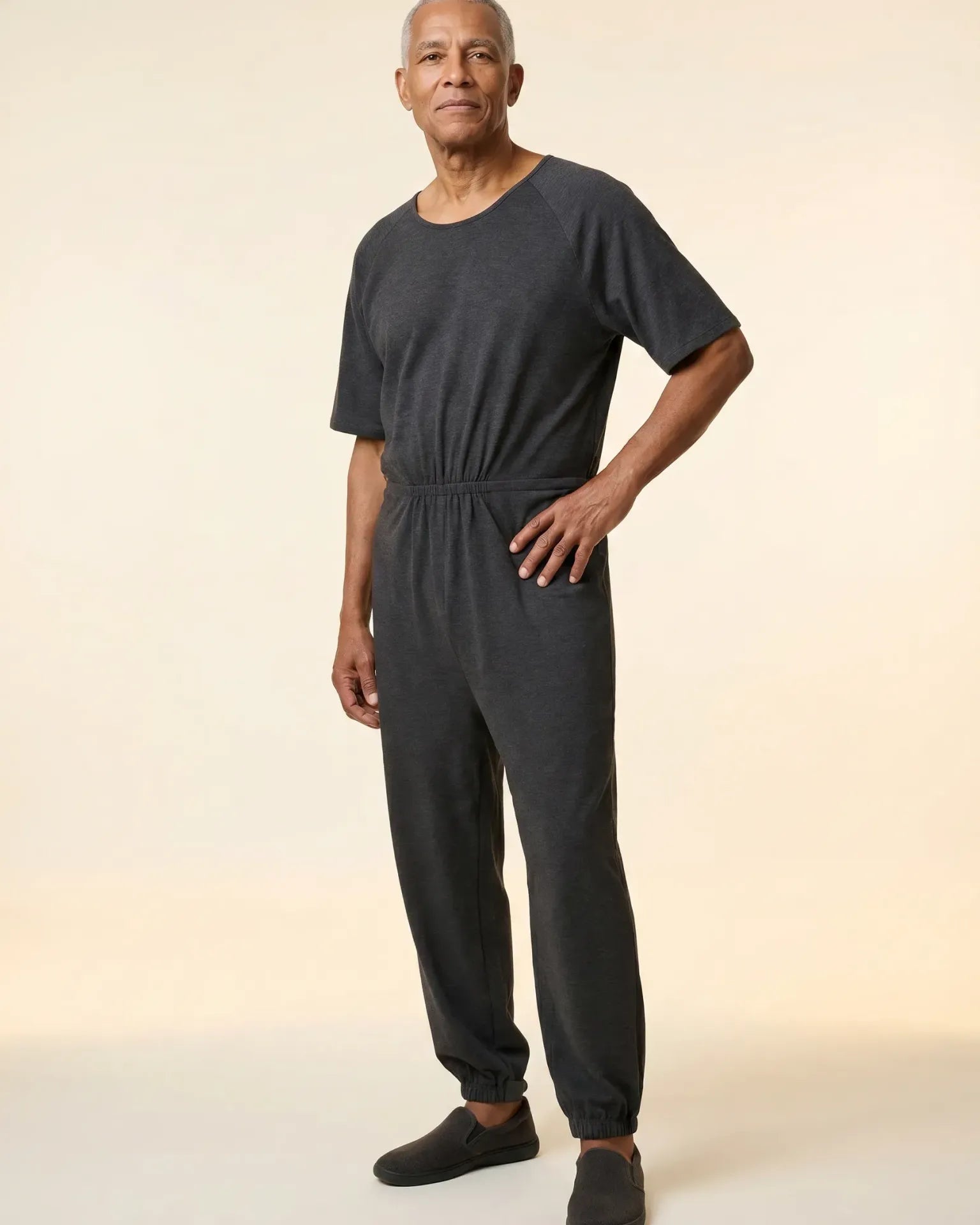 Senior man wearing Ovidis adaptive Bobby Grey jumpsuit, full body front view