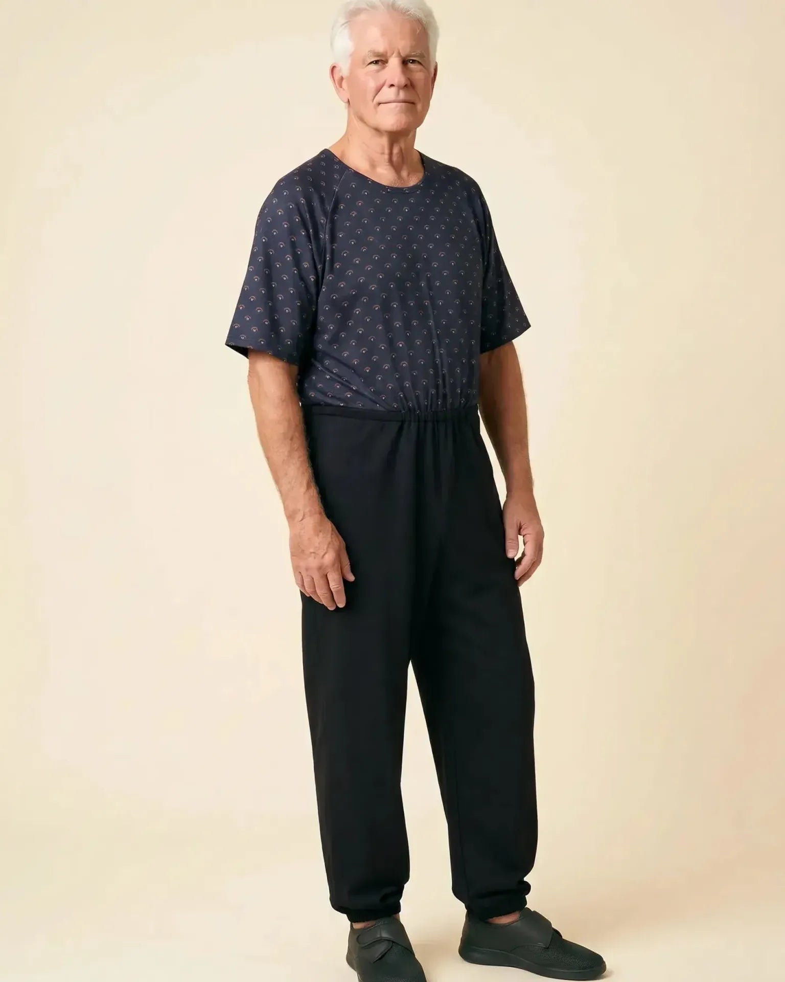 Senior man wearing Ovidis adaptive Bobby Copper jumpsuit, full body front view