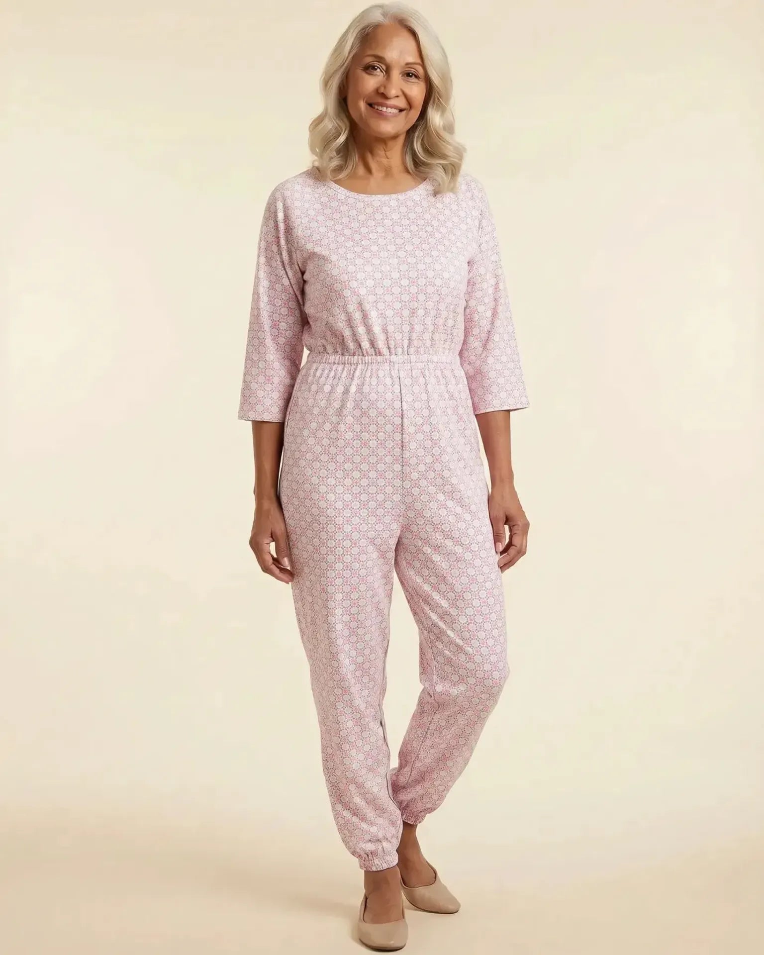 Senior woman wearing Ovidis adaptive Carrie Blush geometric jumpsuit, full body front view