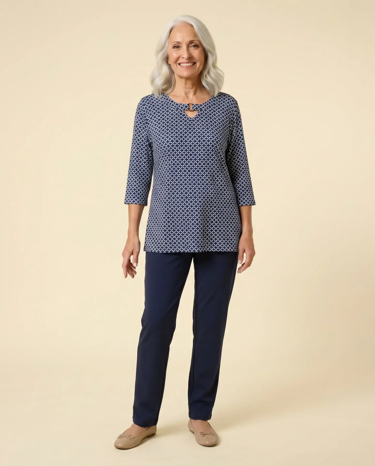 Senior woman wearing Ovidis adaptive navy patterned knit top with ring neckline detail, easy dressing