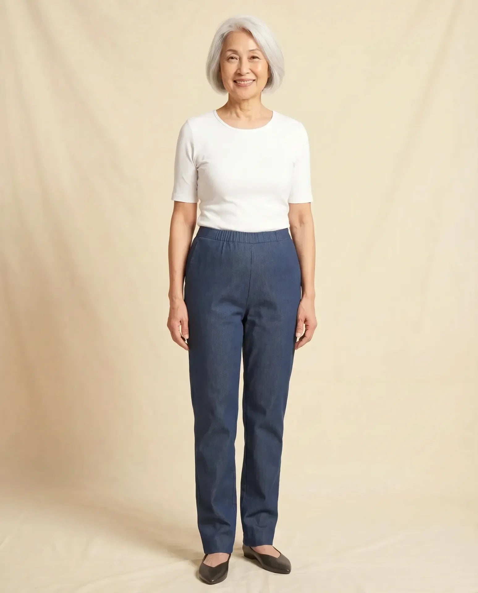 Senior Asian woman wearing Ovidis Arie Jeans in Denim, clean front panel, full body front view