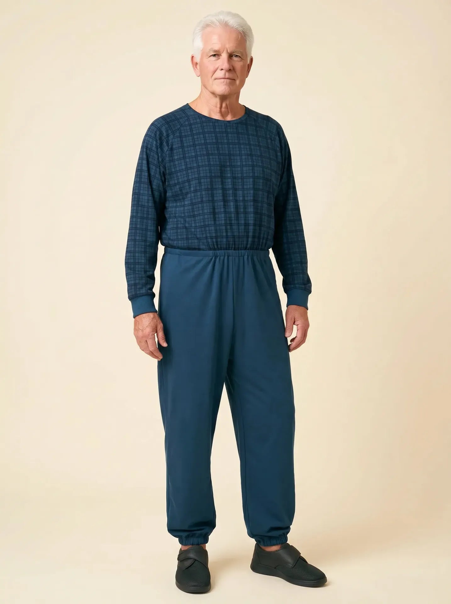 Senior man wearing Ovidis adaptive Henry Navy Check jumpsuit, front view, warm studio lighting