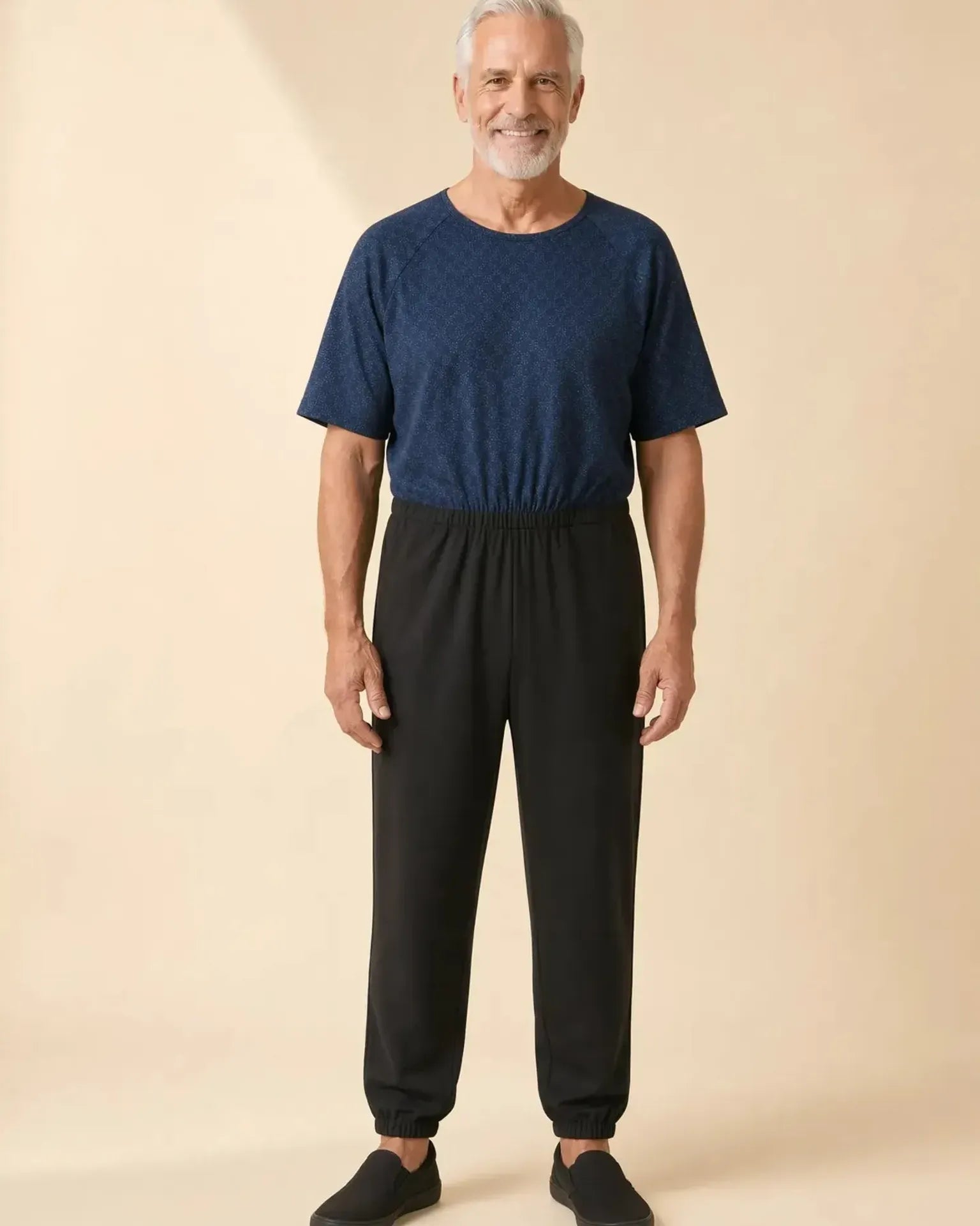Senior man wearing Ovidis adaptive Bobby Starlight jumpsuit, full body front view