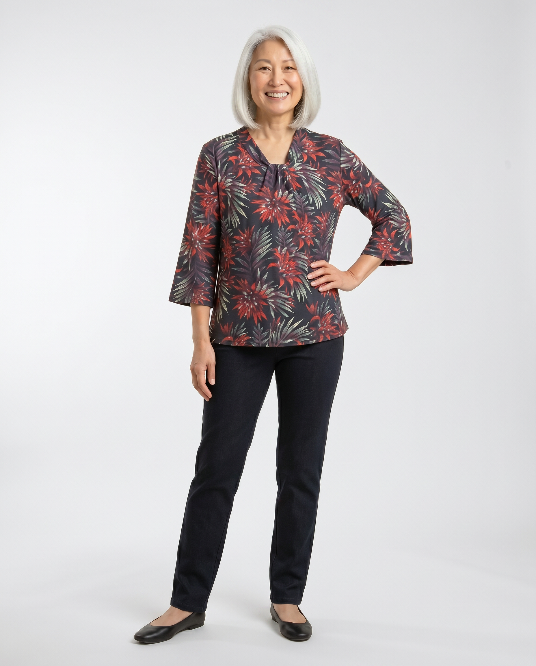 Senior woman wearing Ovidis adaptive tropical floral top with knotted V-neckline and wide sleeves, easy dressing