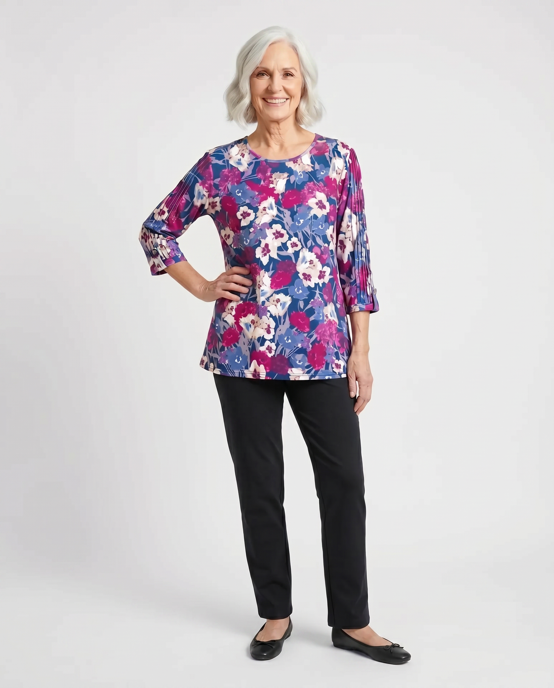 Senior woman wearing Ovidis adaptive fuchsia micro pique top with shirred sleeve detail, easy dressing
