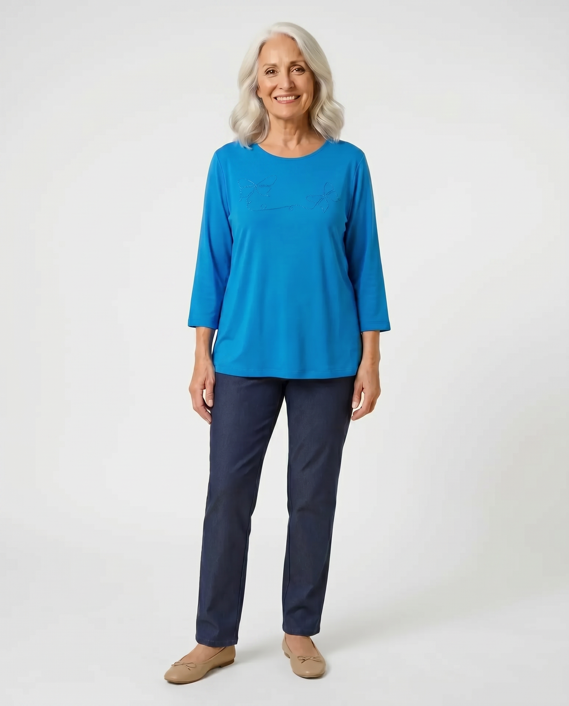 Senior woman wearing Ovidis adaptive sky blue top with butterfly appliqué, easy dressing for seniors