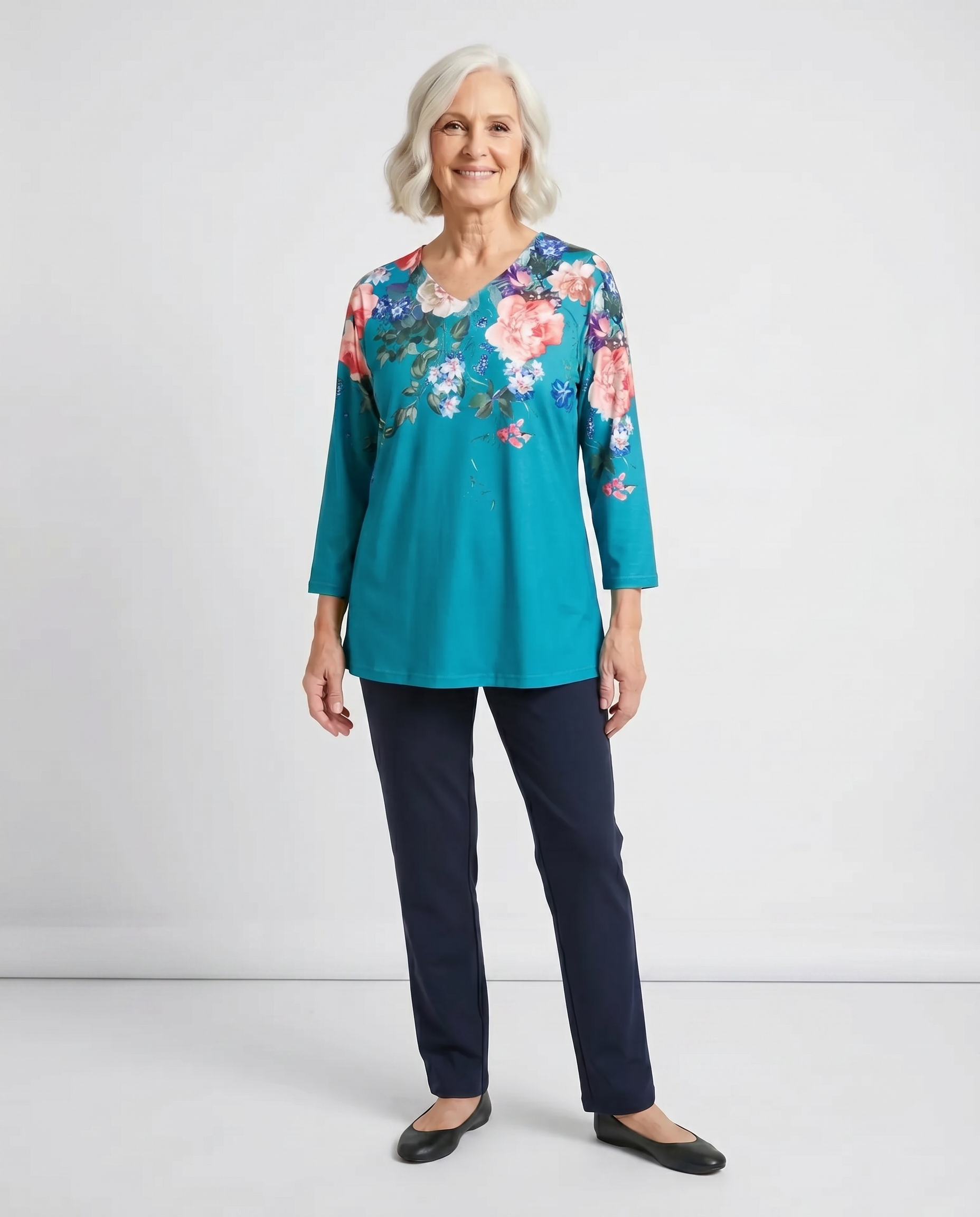 Senior woman wearing Ovidis adaptive turquoise floral top, easy assisted dressing