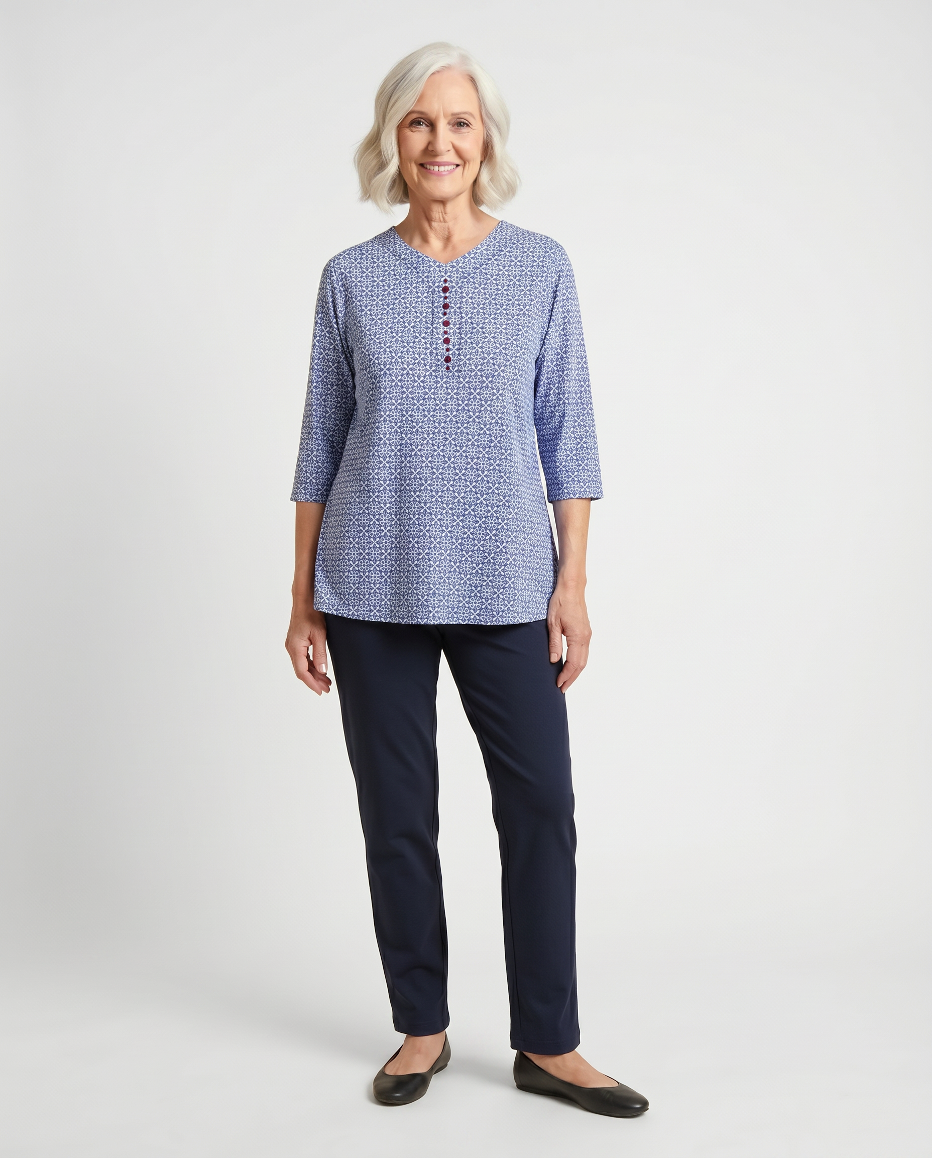 Senior woman wearing Ovidis adaptive blue daisy print top with burgundy button detail, easy dressing