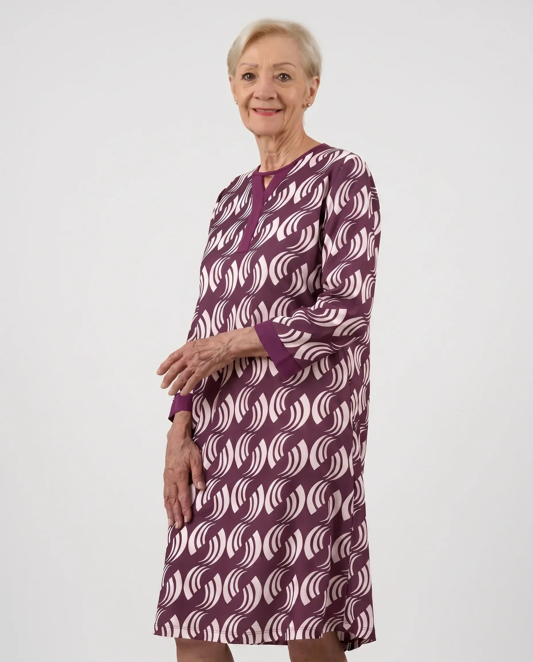 Senior woman wearing Lisa Plum adaptive dress with wave scroll print, front view