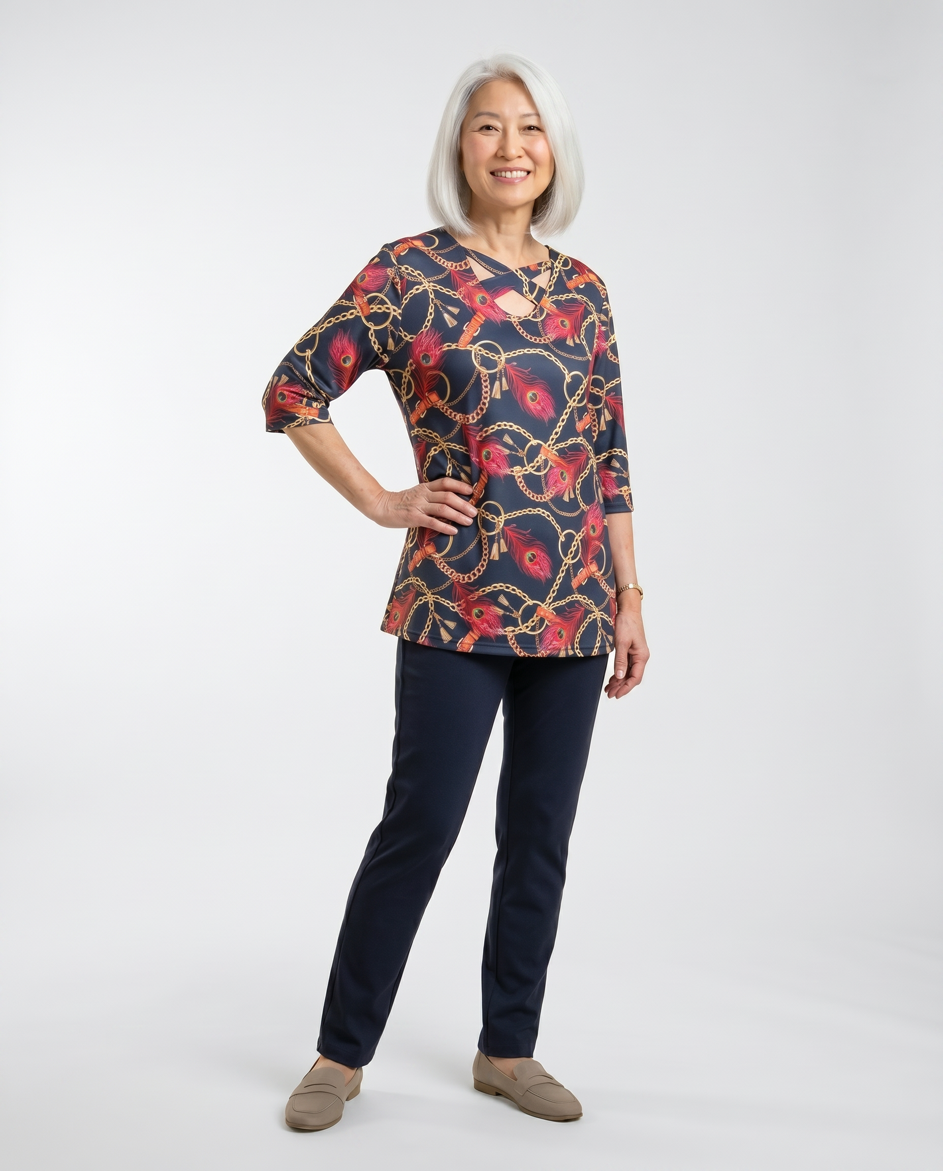 Senior woman wearing Ovidis adaptive navy Lizzy top with chain and feather print, easy assisted dressing
