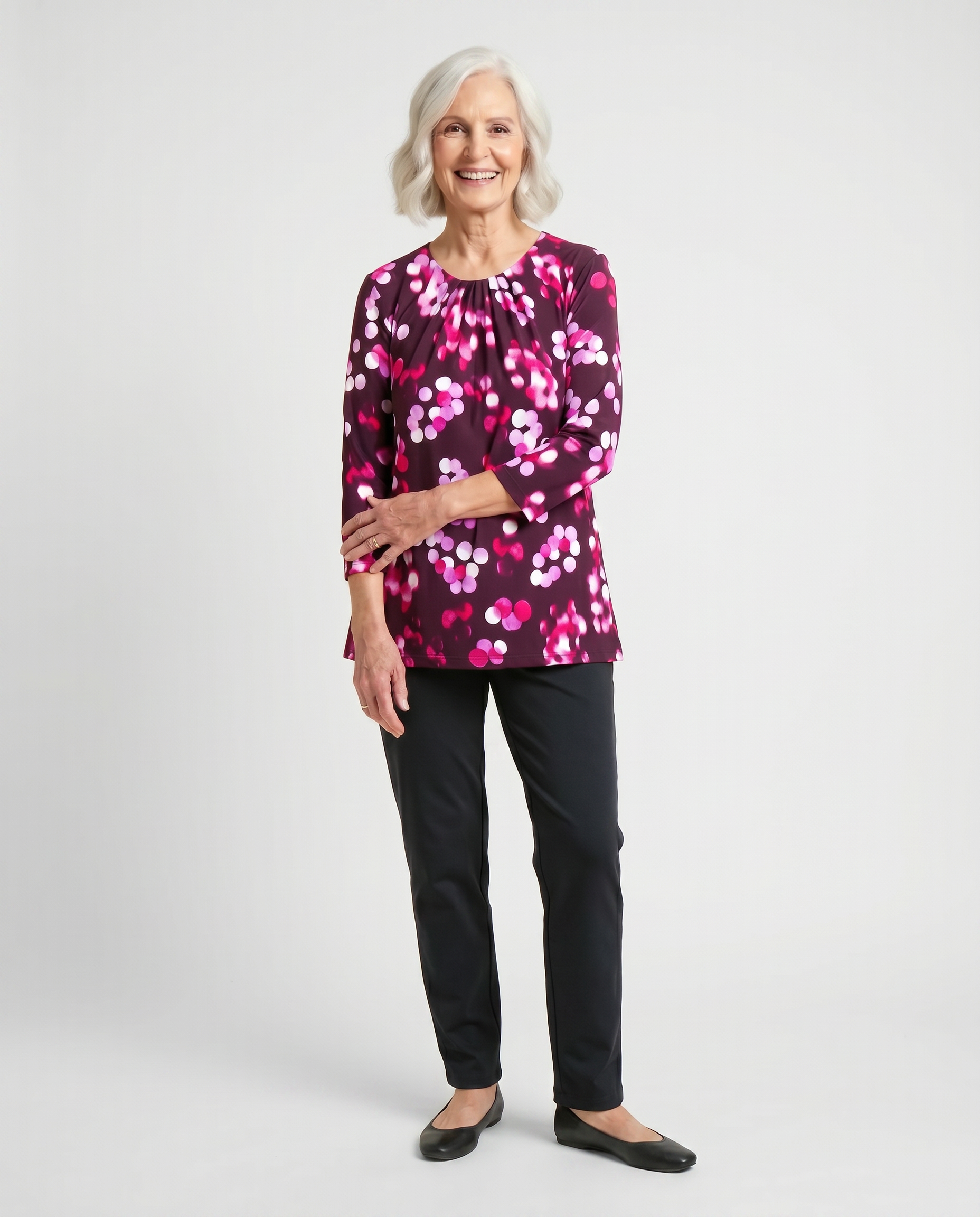 Senior woman wearing Ovidis adaptive fuchsia bokeh print top with gathered neckline, easy dressing