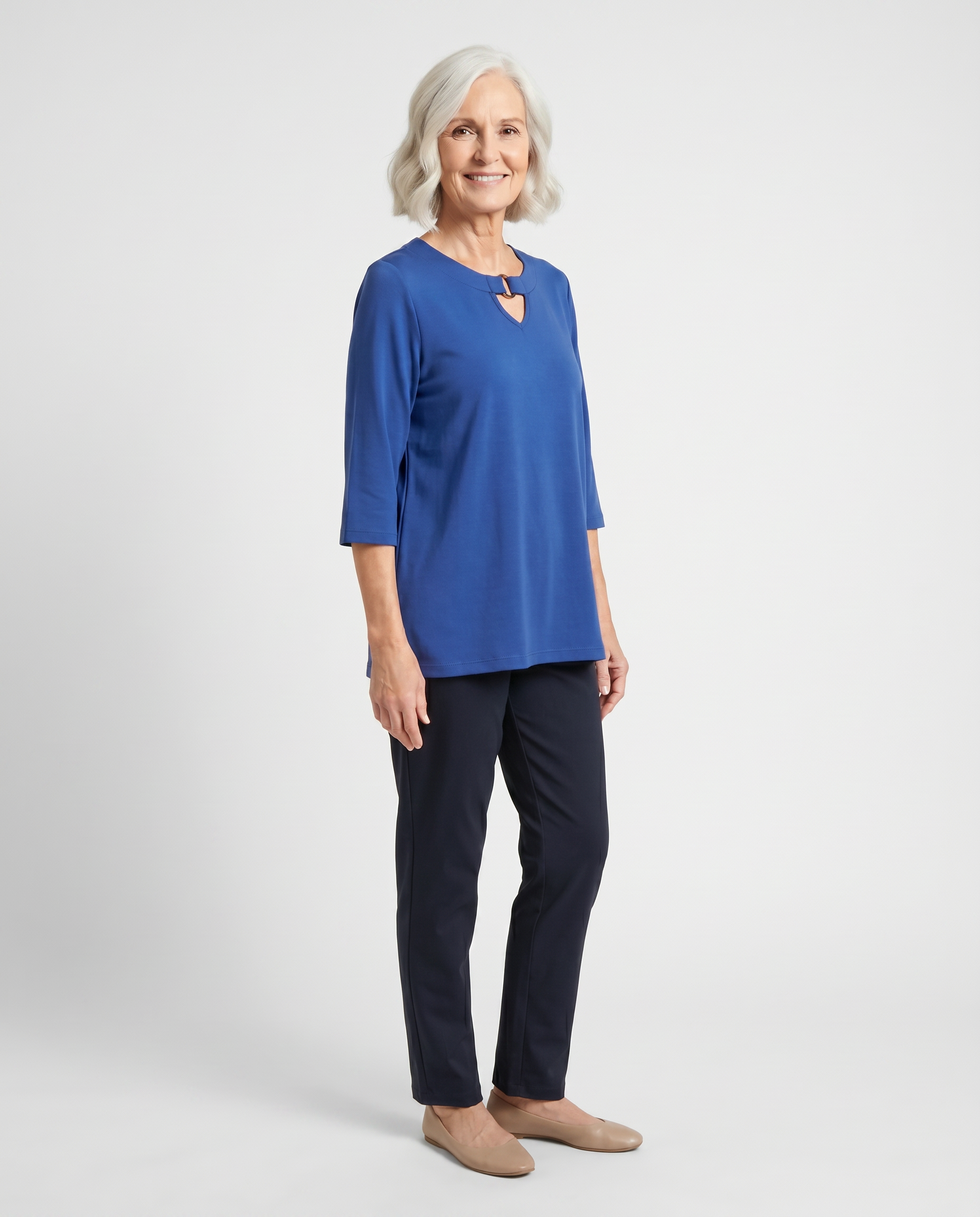 Senior woman wearing Ovidis adaptive blue knit top with keyhole neckline, easy assisted dressing
