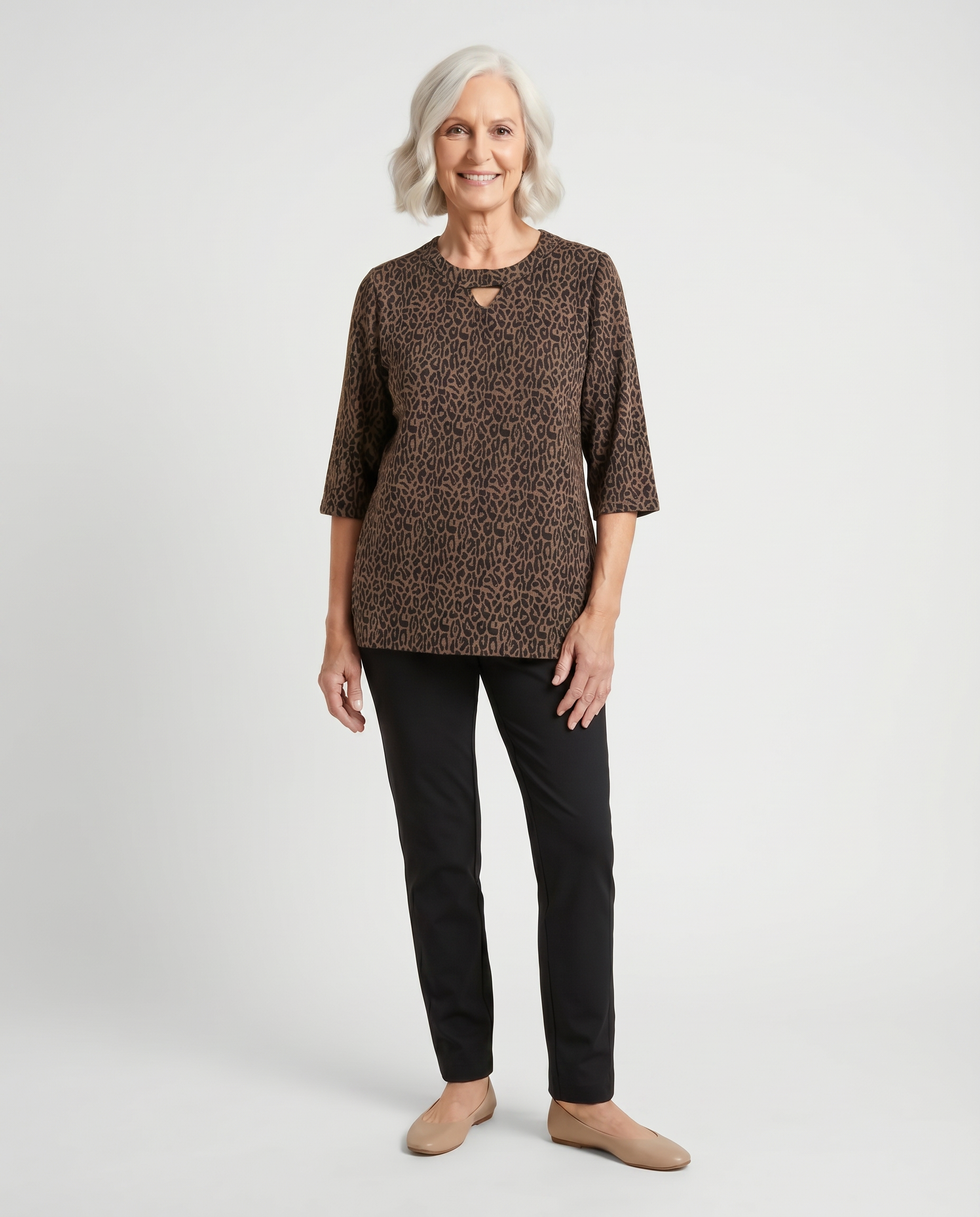 Senior woman wearing adaptive leopard jacquard knit top with keyhole neckline, paired with black pants